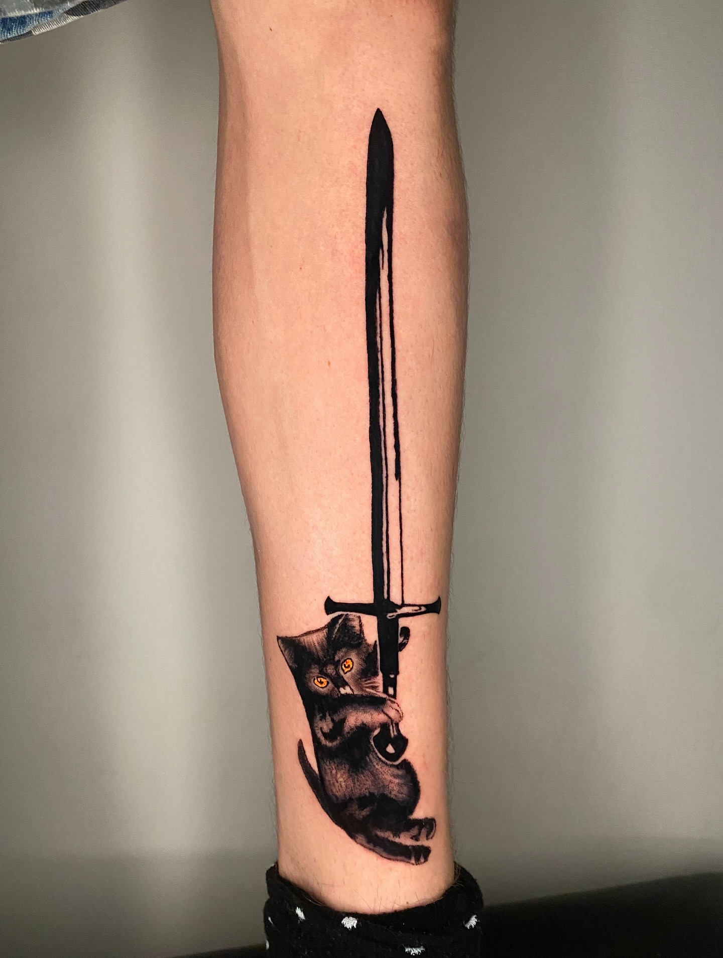 Cat and sword realism tattoo on the forearm by Aidan Leery, Portland, Oregon