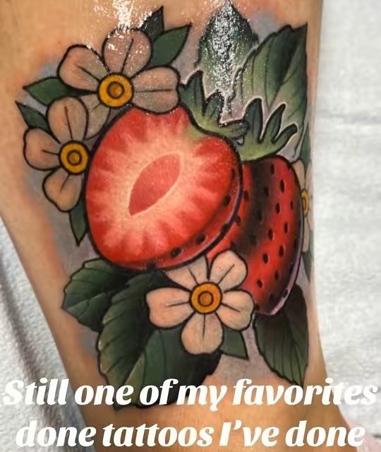 Strawberry and flowers American traditional tattoo on the forearm by Jake lyon