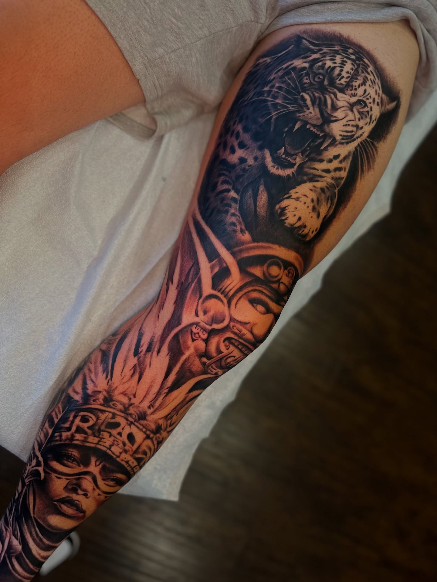 Leopard and warrior realism tattoo on the forearm by Ray Ochoa
