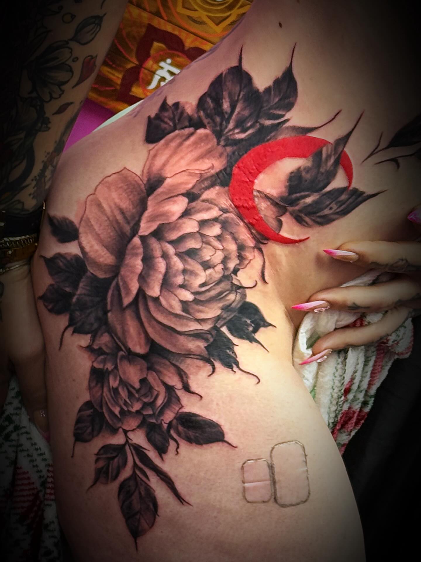 Peony and crescent moon realism tattoo on the shoulder by Skunk Punk