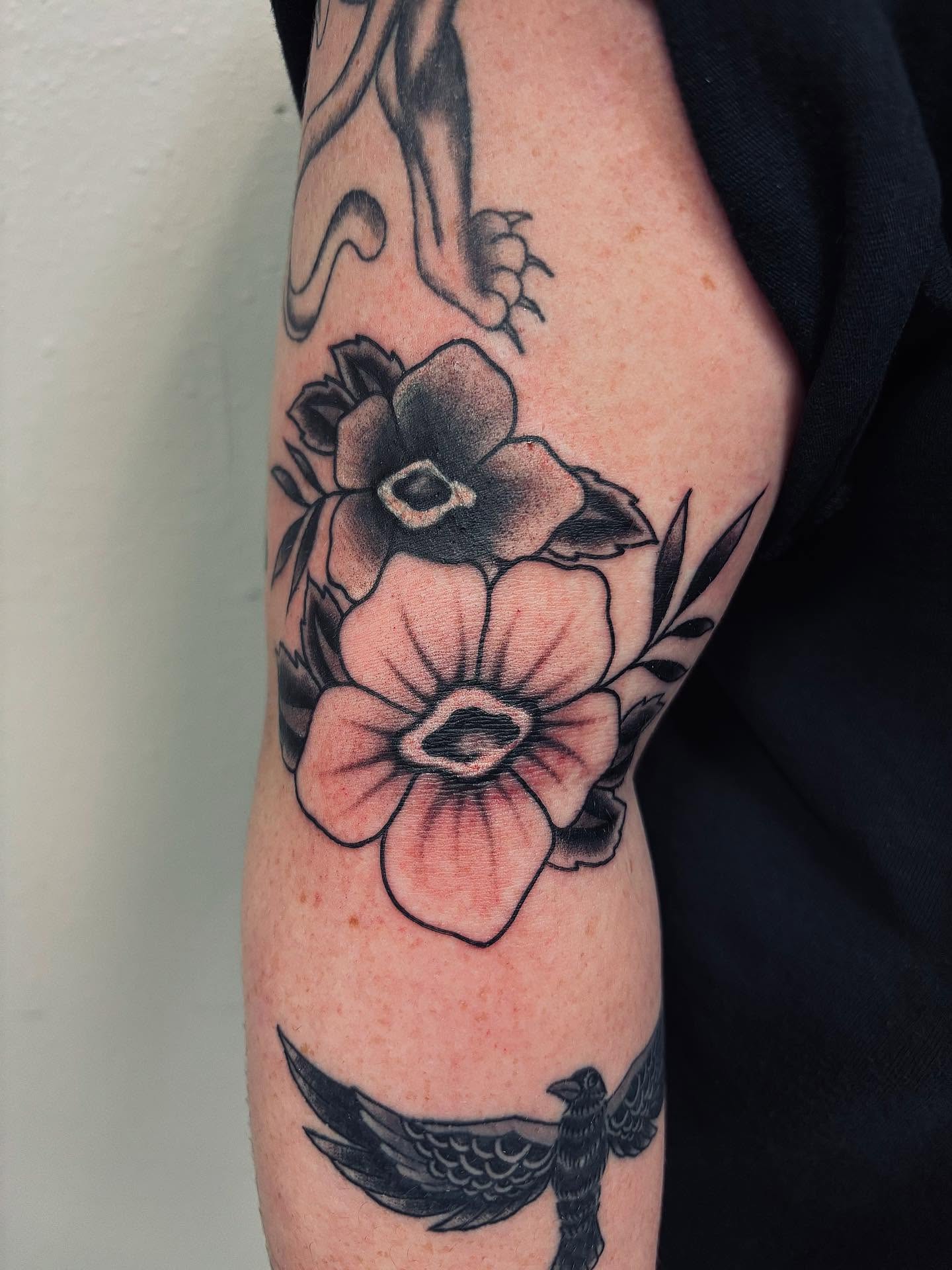 Flowers and bird black and grey tattoo on the forearm by Brii Moser