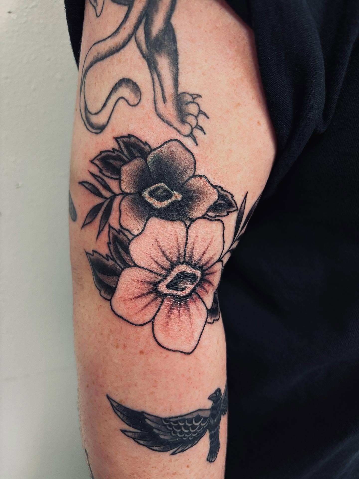 Flowers and bird black and grey tattoo on the forearm by Brii Moser
