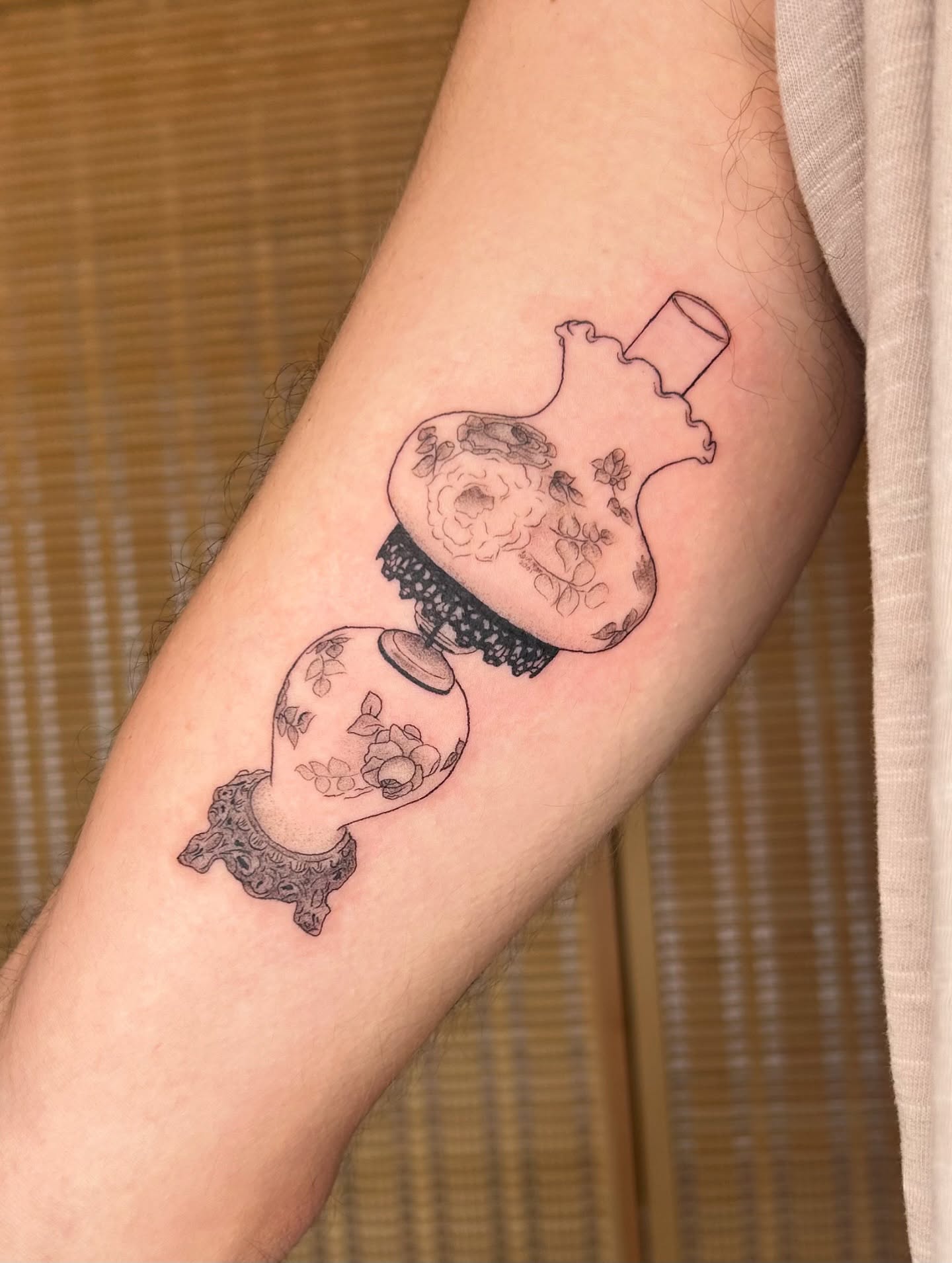 Heart with floral elements black and grey tattoo on the forearm by beth