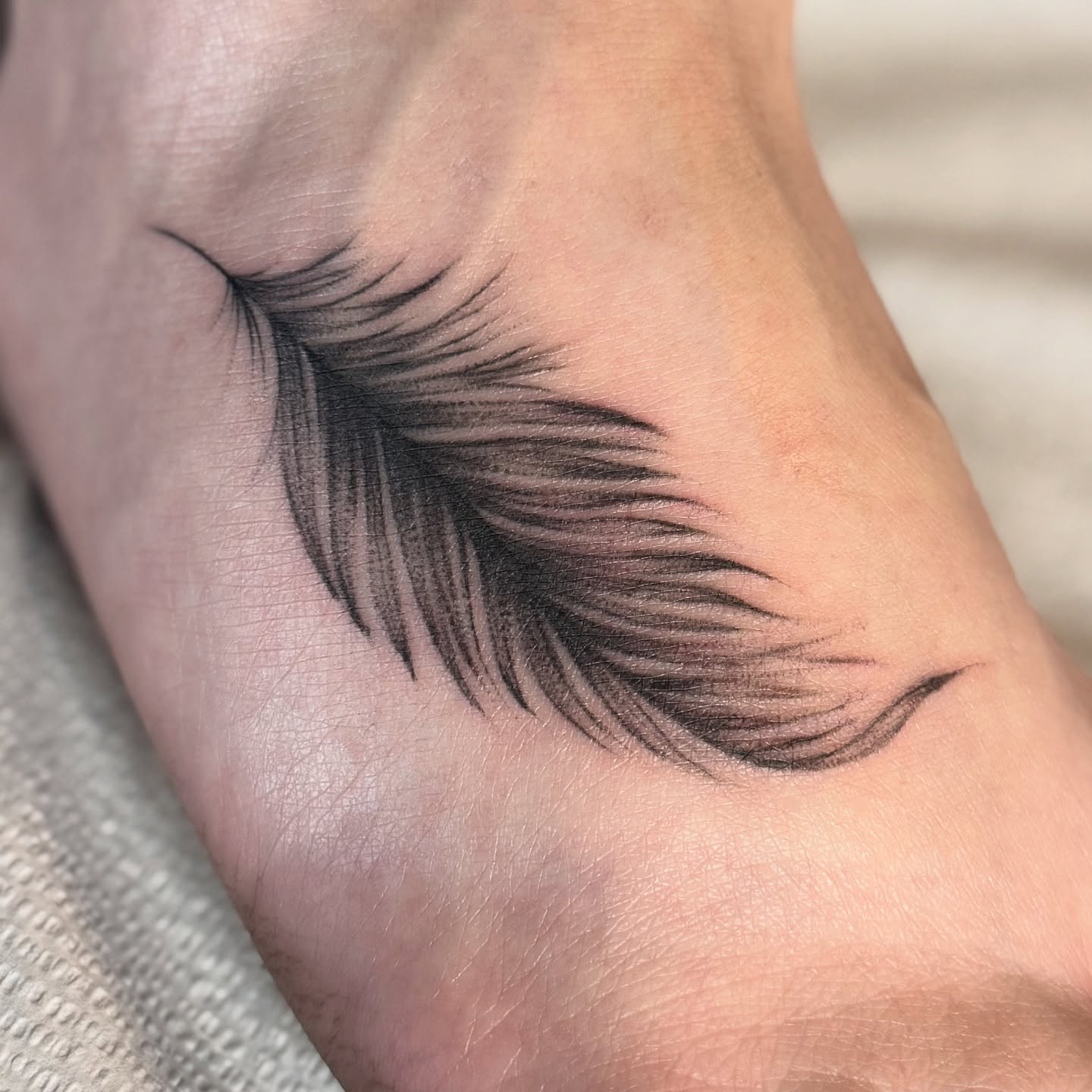 Eyelashes black and grey tattoo on the forearm by Hali Larkin