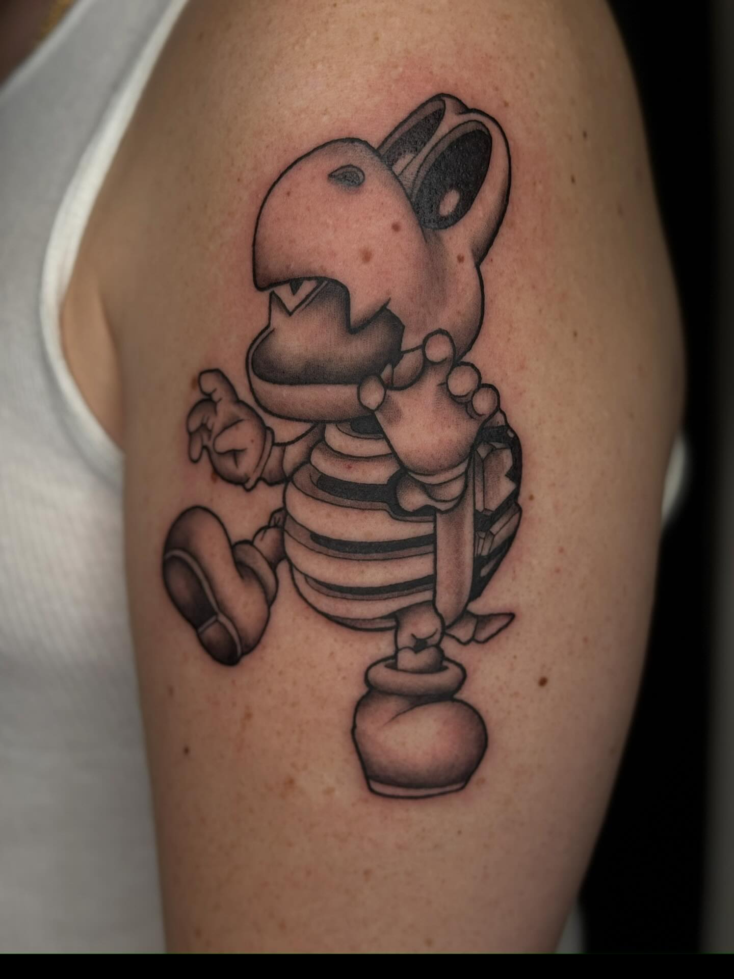 Robot baby black and grey tattoo on the upper arm by Ashley Hsiung *Panda*