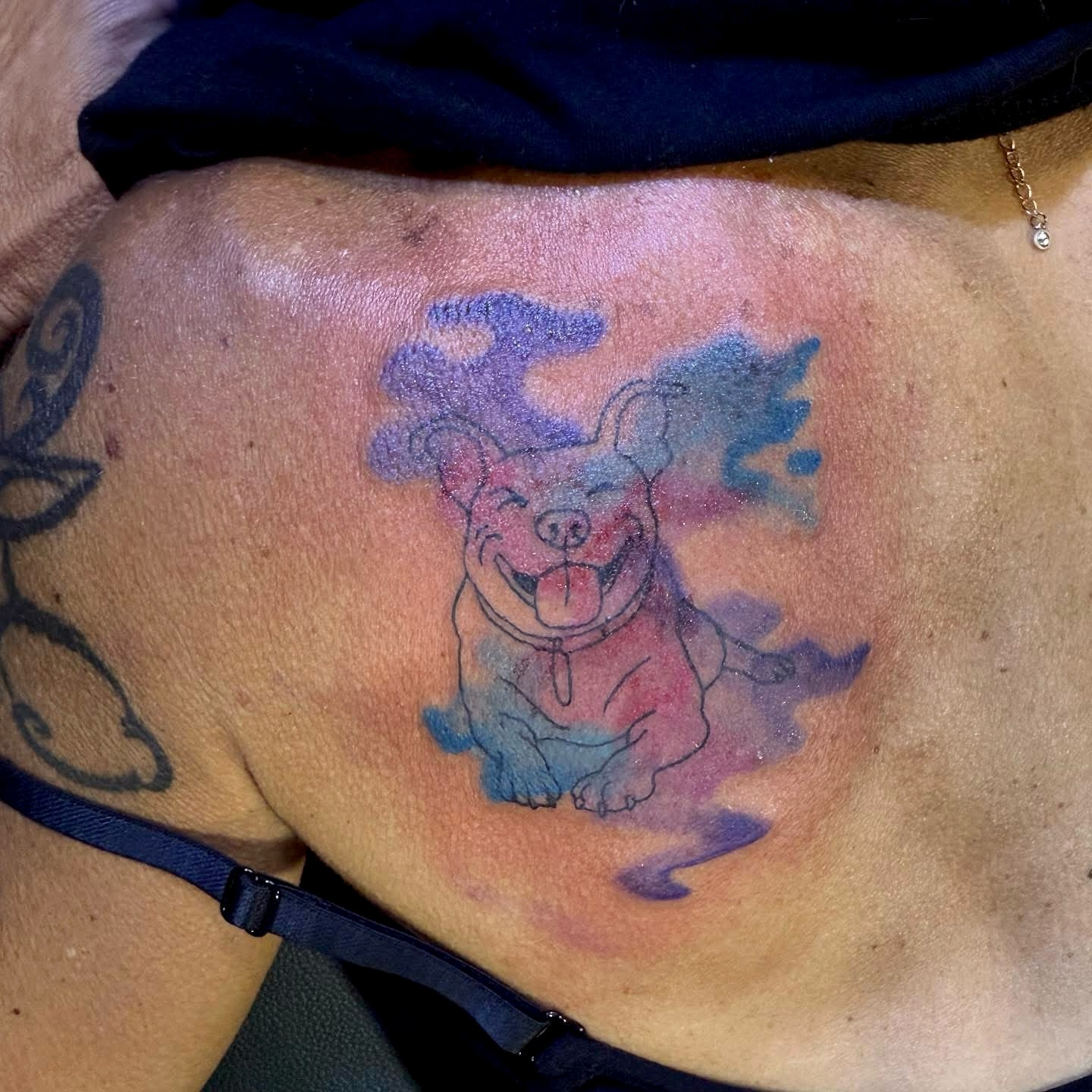 Happy dog watercolor tattoo on the chest by Minxxy Tattoos