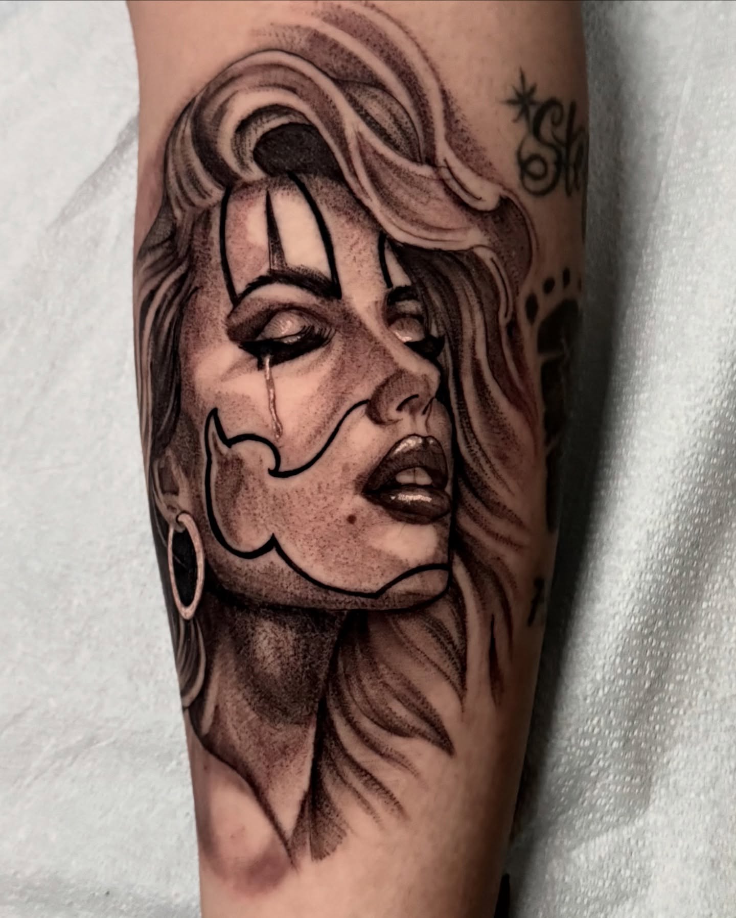 Woman with crying eyes realism tattoo on the forearm by Tattoo Artist