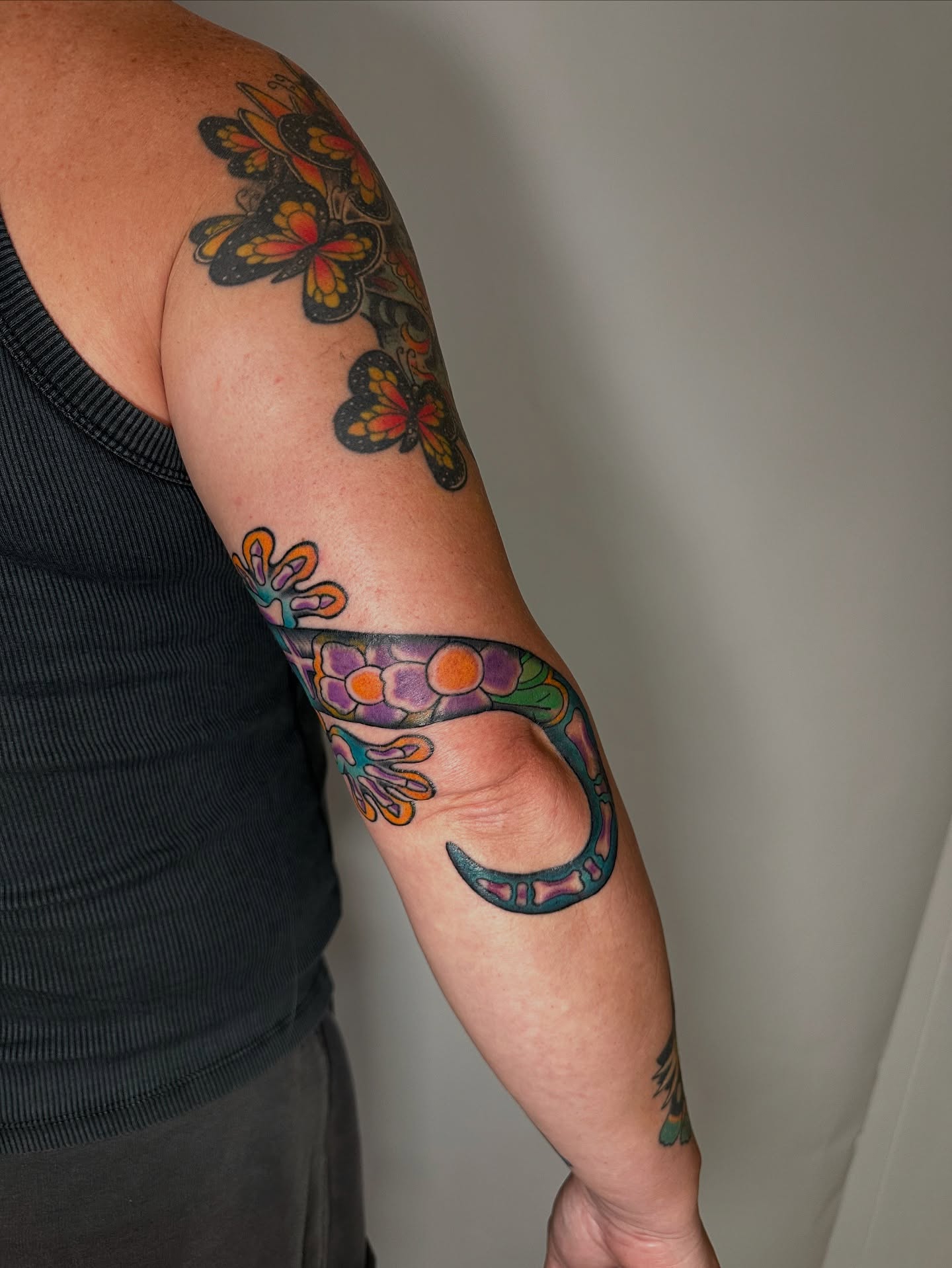 Snake and flowers new school tattoo on the forearm by Heather Cherish