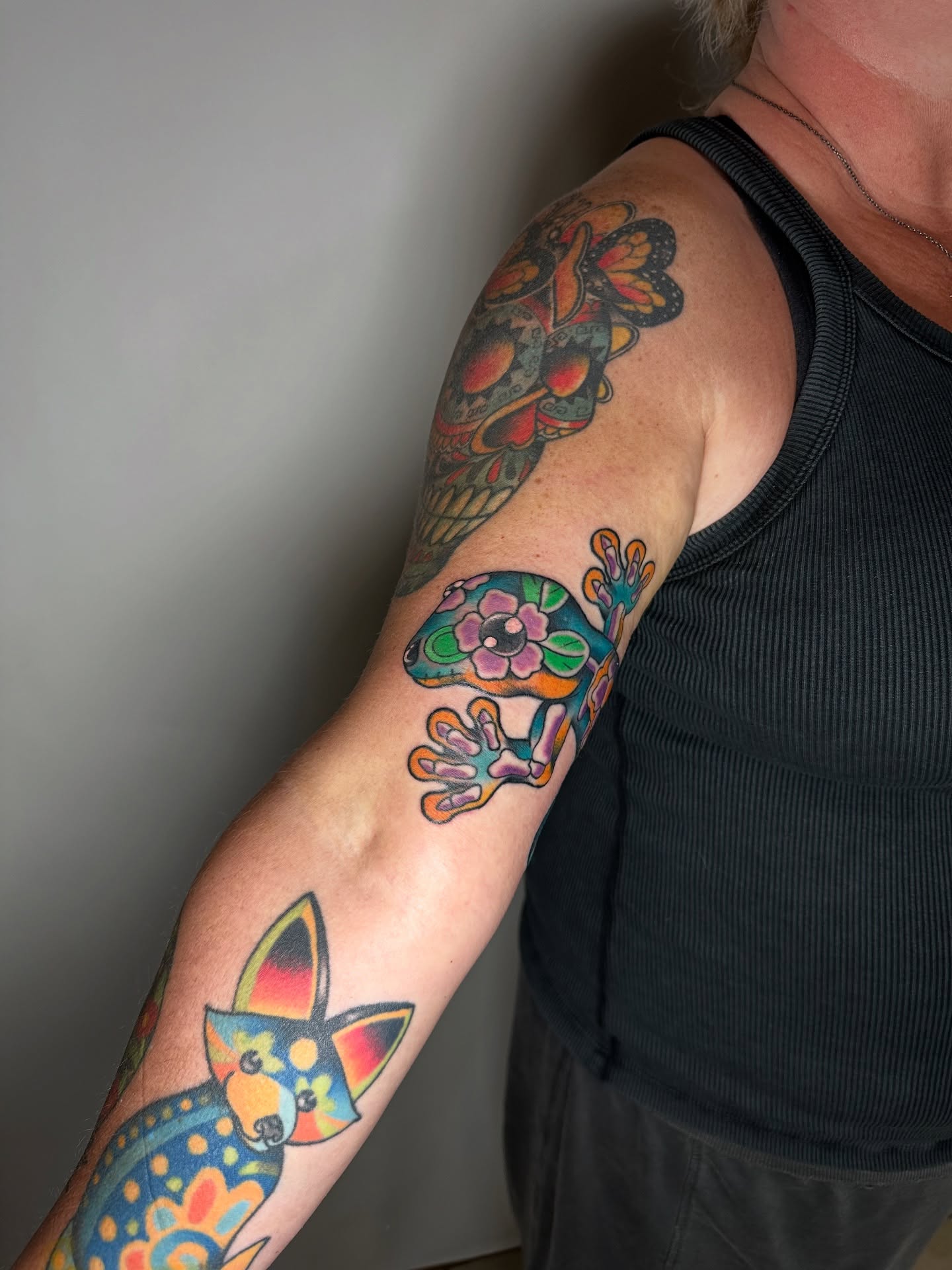 Gecko and flower American traditional tattoo on the forearm by Heather Cherish