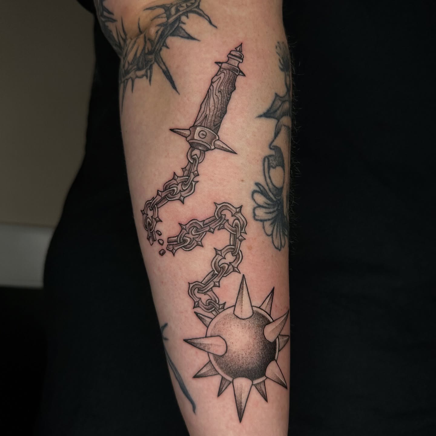 Chain and dagger black and grey tattoo on the forearm by sechi