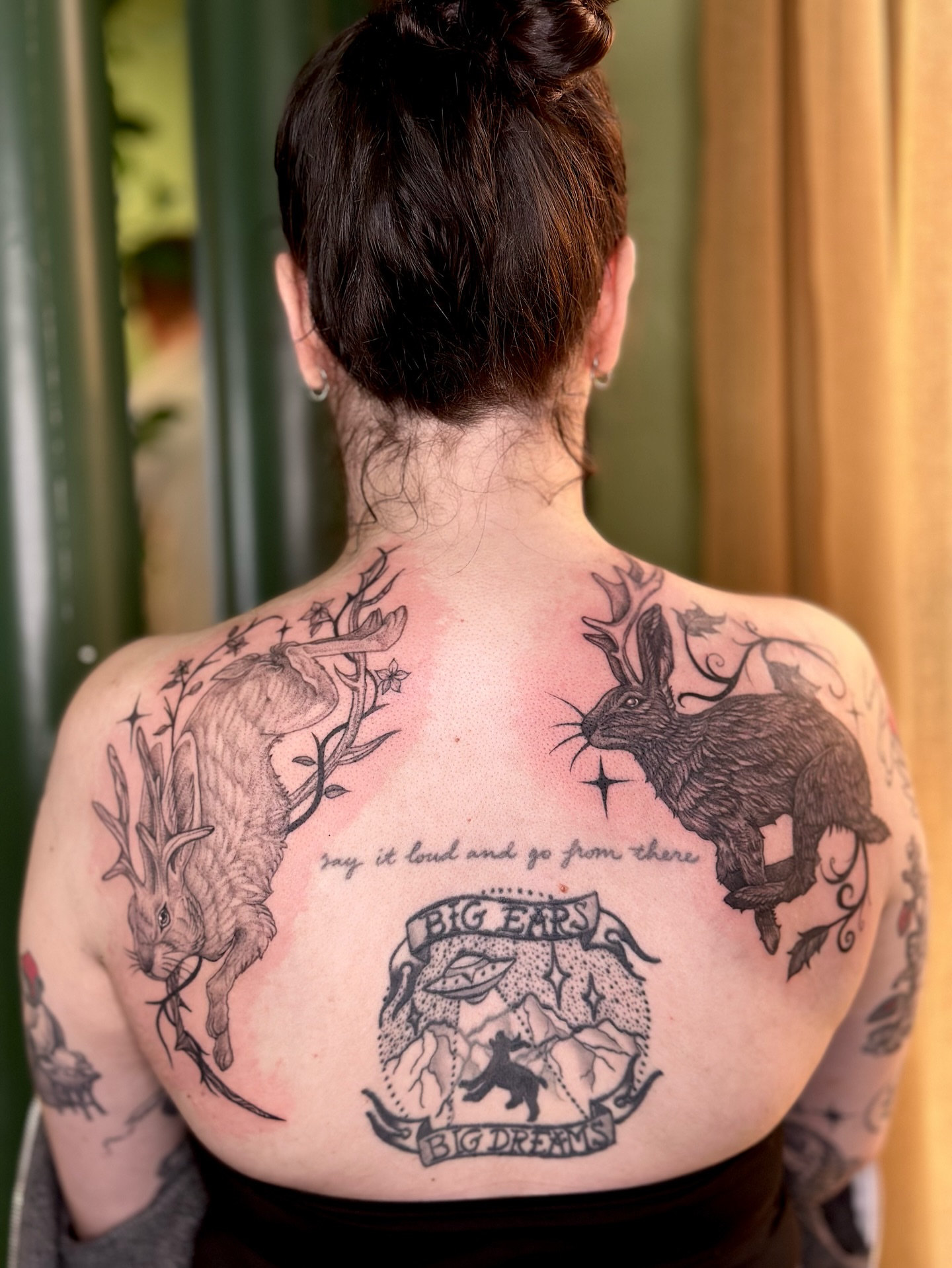 Rabbit and deer black and grey tattoo on the back by cora cupid