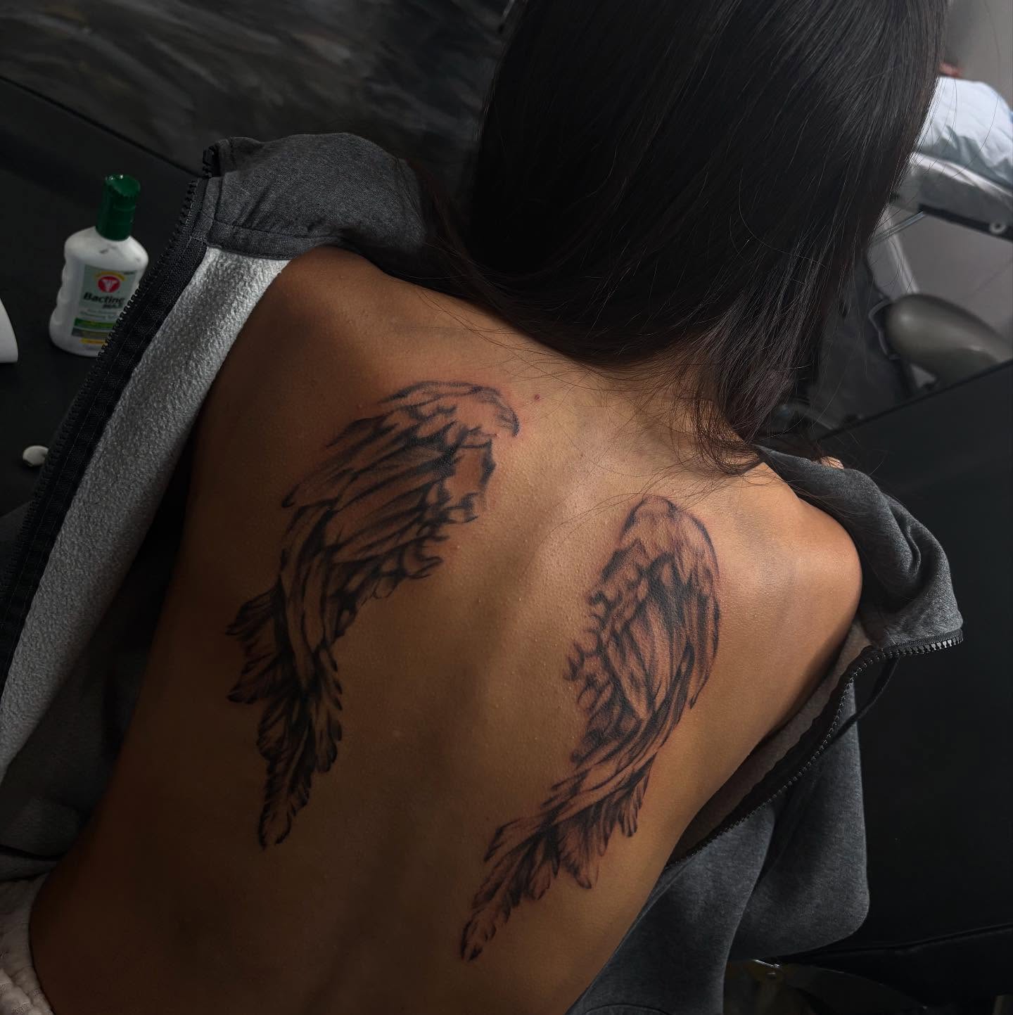 Wings black and grey tattoo on the back by Kevin