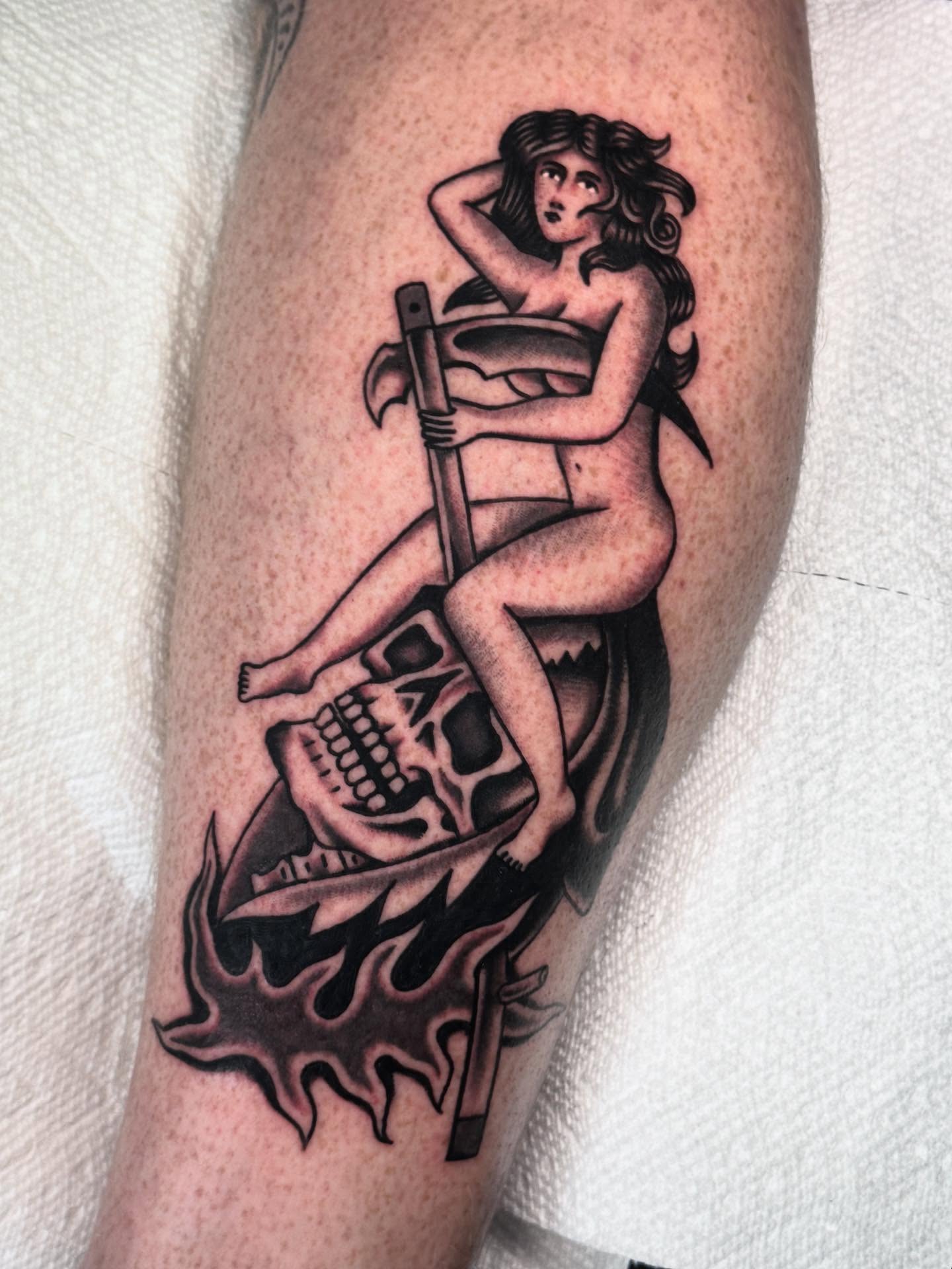 Naked woman on skull American traditional tattoo on the forearm by Ryan Engels