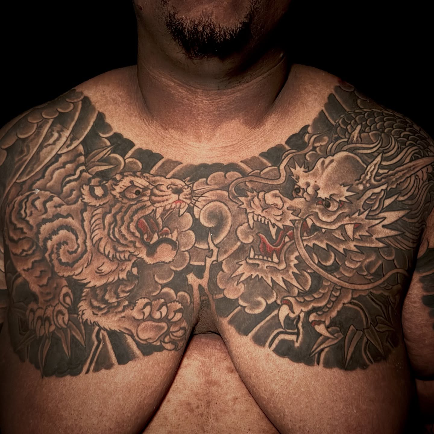 Dragon and tiger japanese irezumi tattoo on the chest by Leif Hansen