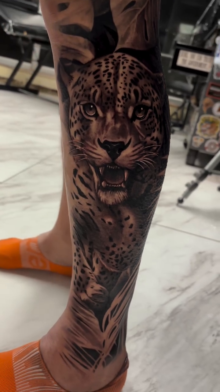 Leopard portrait with foliage realism tattoo by Anthony Coleman, Midland, Texas
