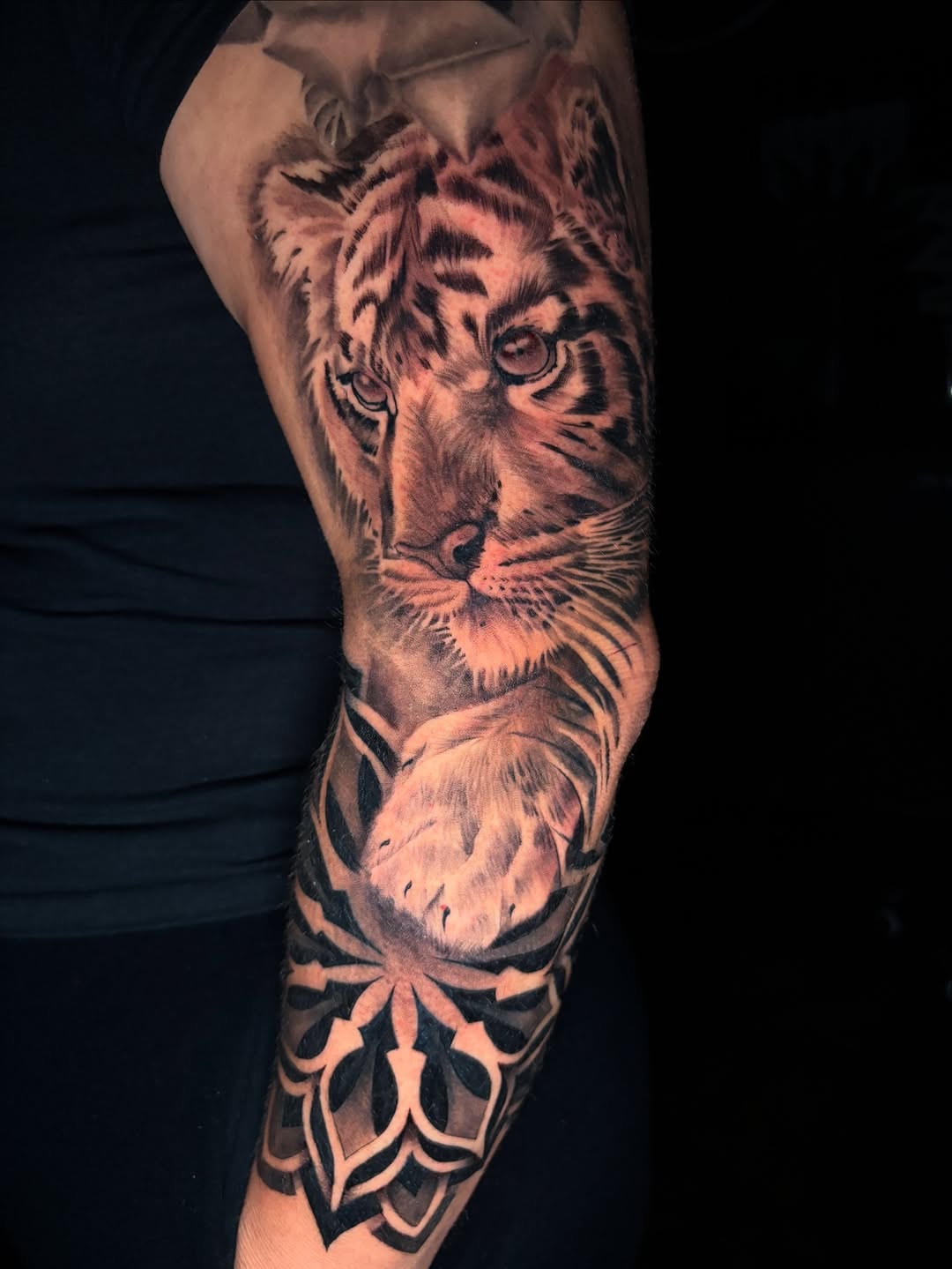 Tiger and ornamental pattern realism tattoo on the forearm by Eric Garcia