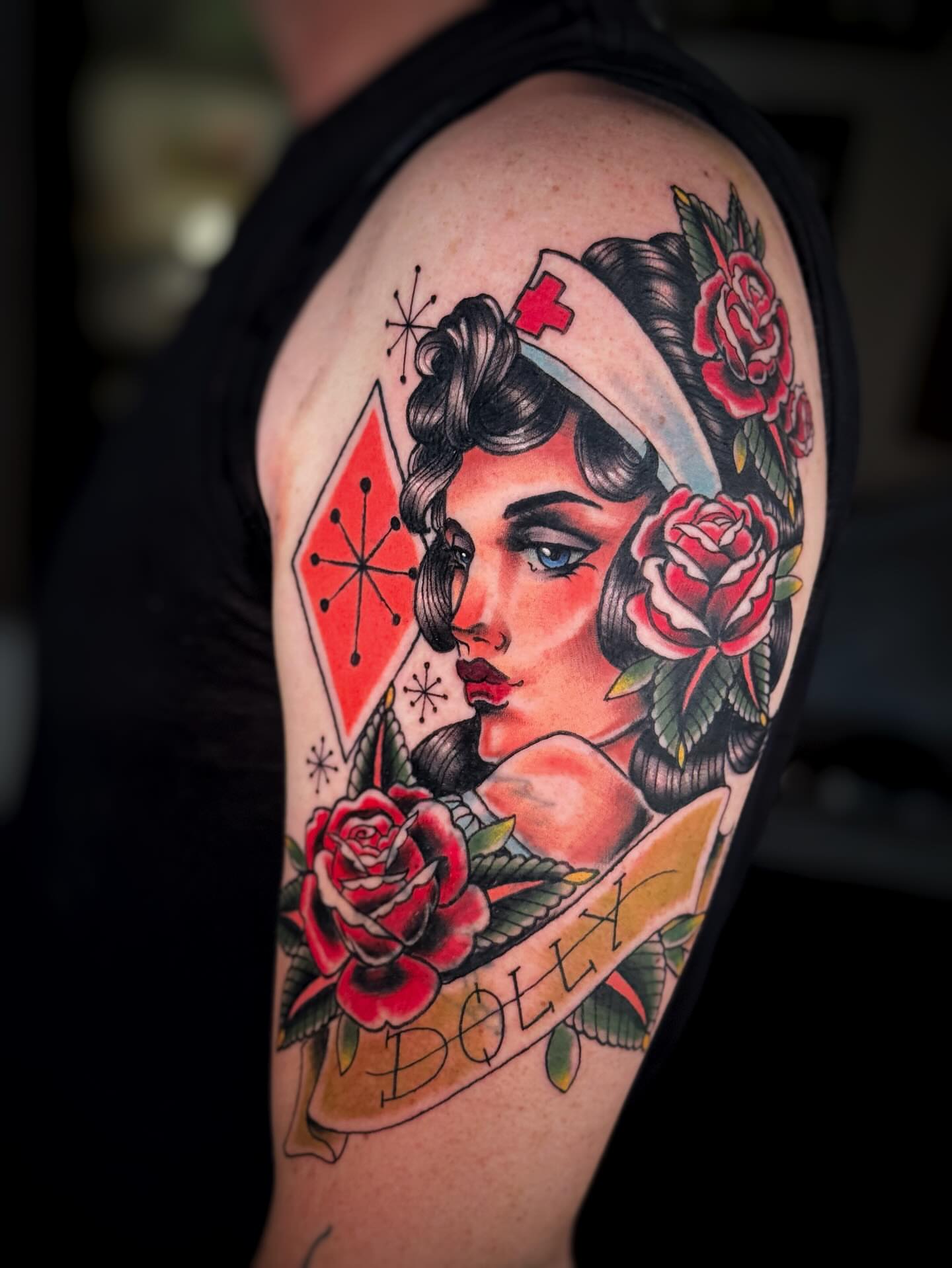 Nurse with roses American traditional tattoo on the shoulder by Anna Saveria