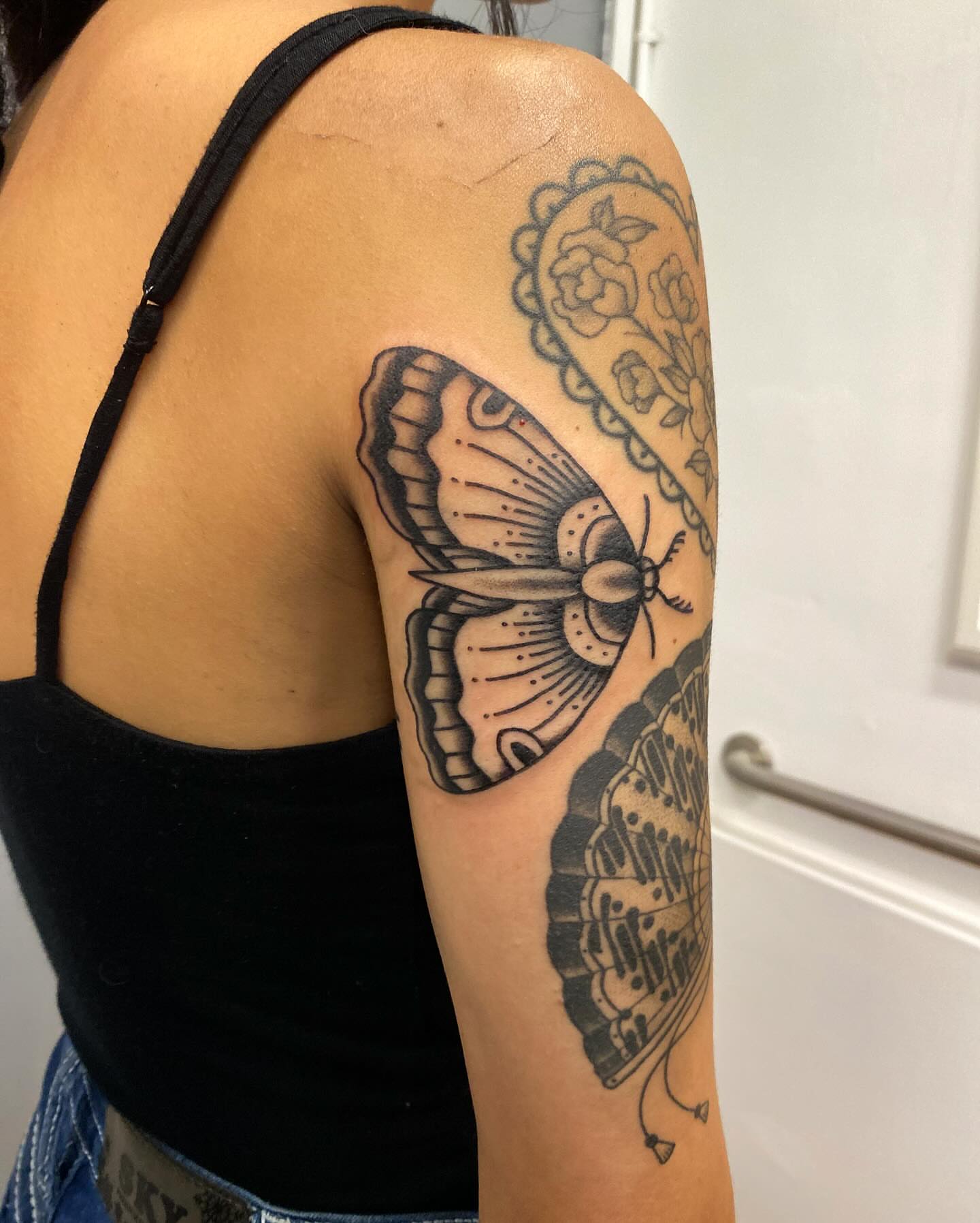 Moth black and grey tattoo on the upper arm by @rubber_band_dan, San Francisco, California