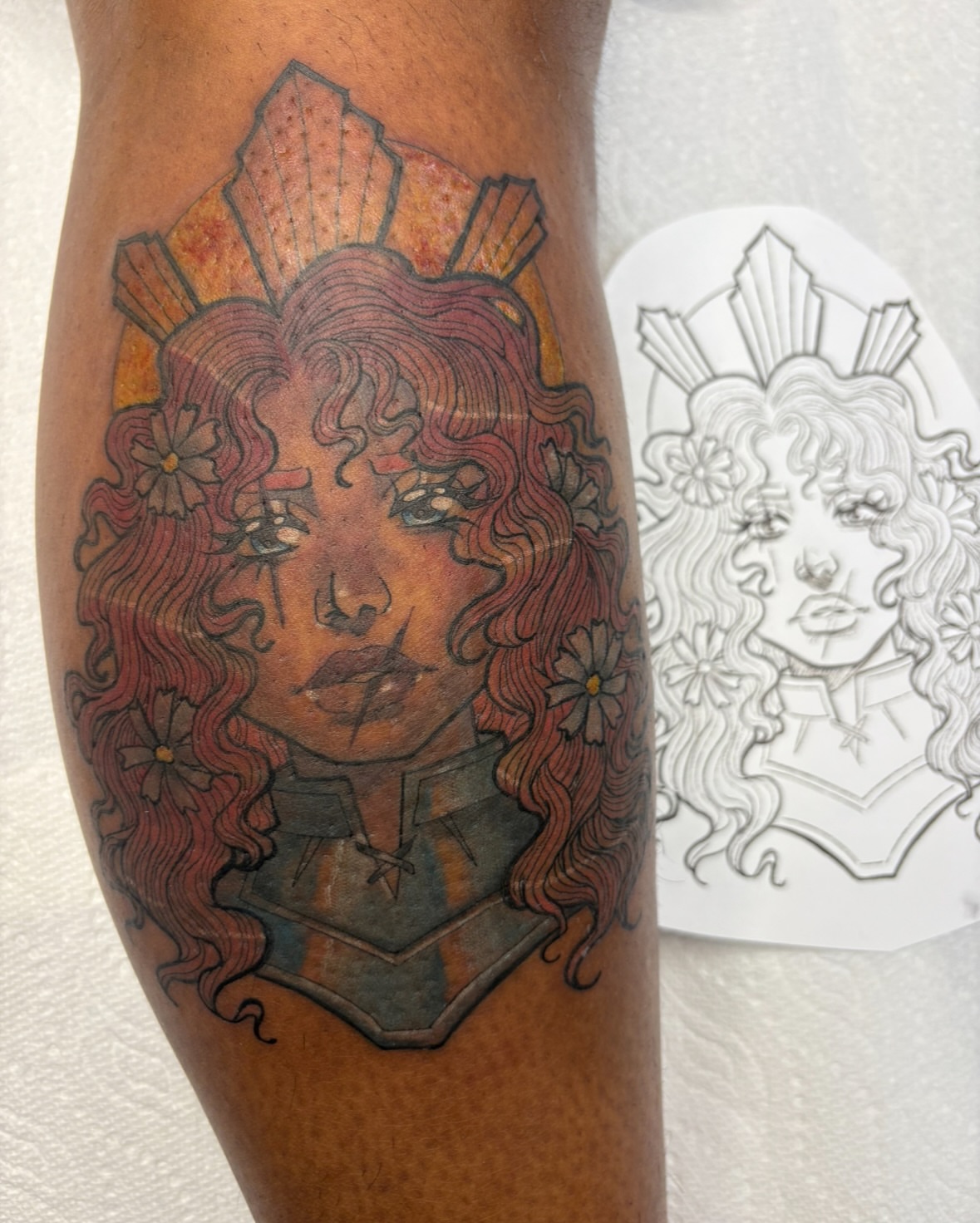 Woman with flowers illustrative tattoo on the forearm by Gabby
