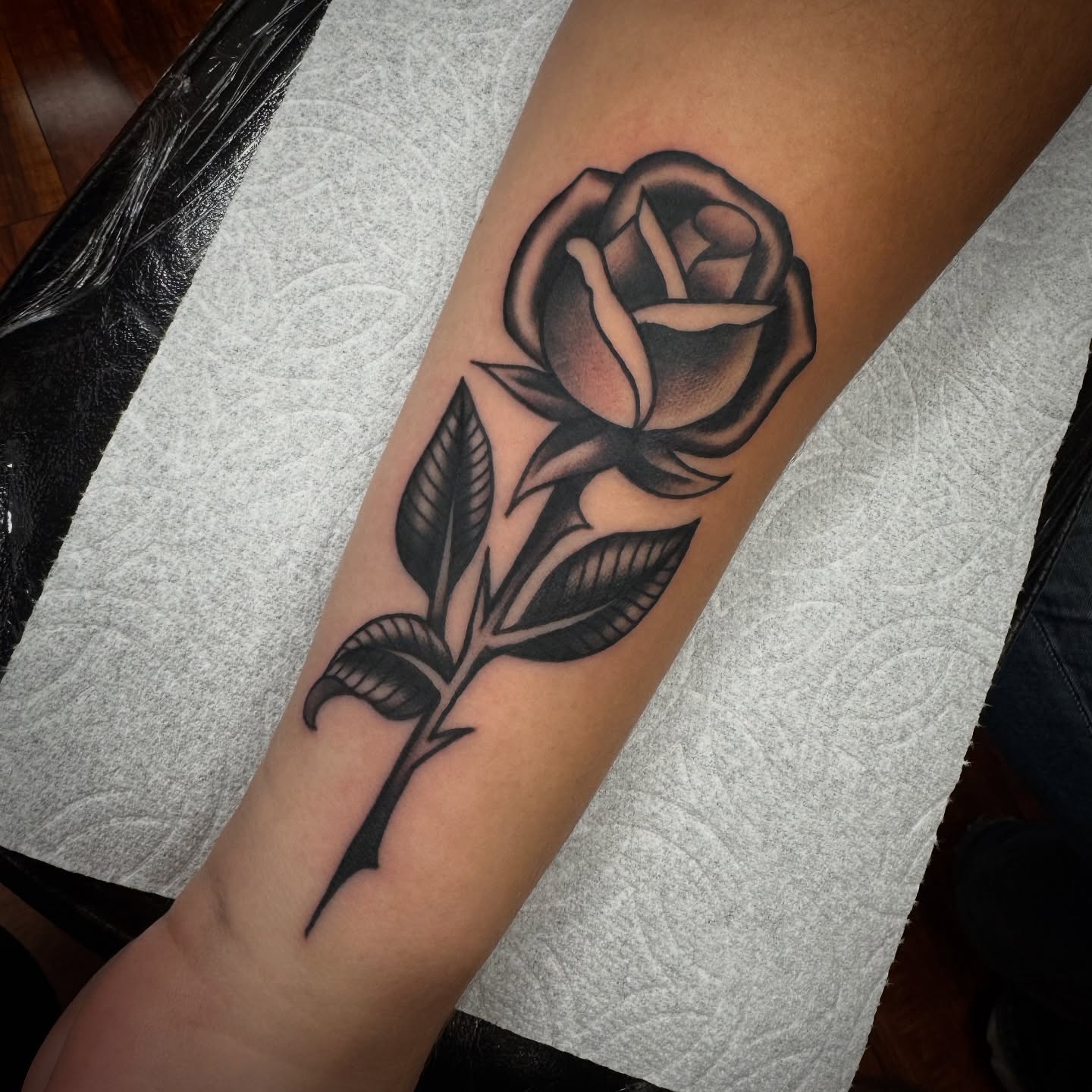 Rose black and grey tattoo on the forearm by Rogelio Robles