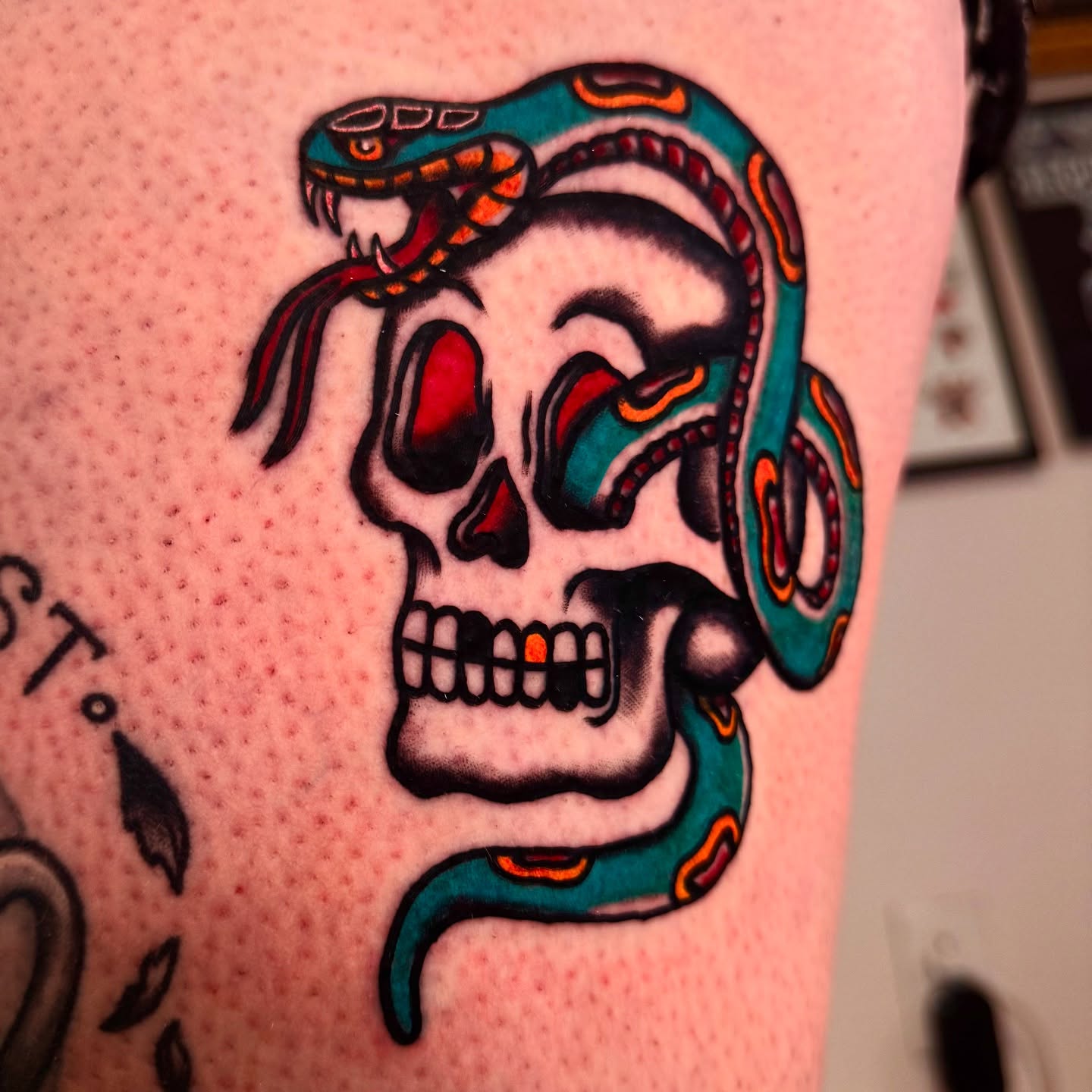 Skull with snake American traditional tattoo on the thigh by Mika