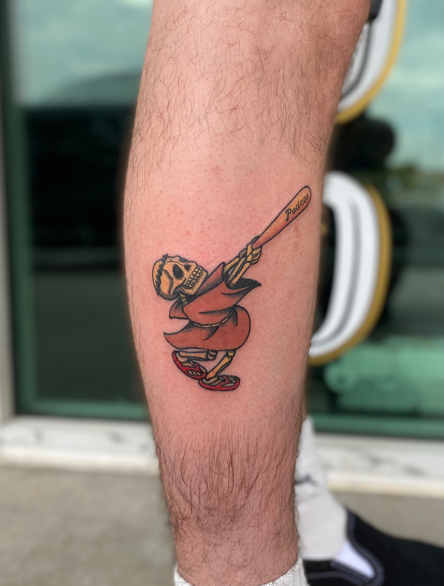 Skull swinging baseball bat American traditional tattoo on the forearm by Elliot Jaye Valentine