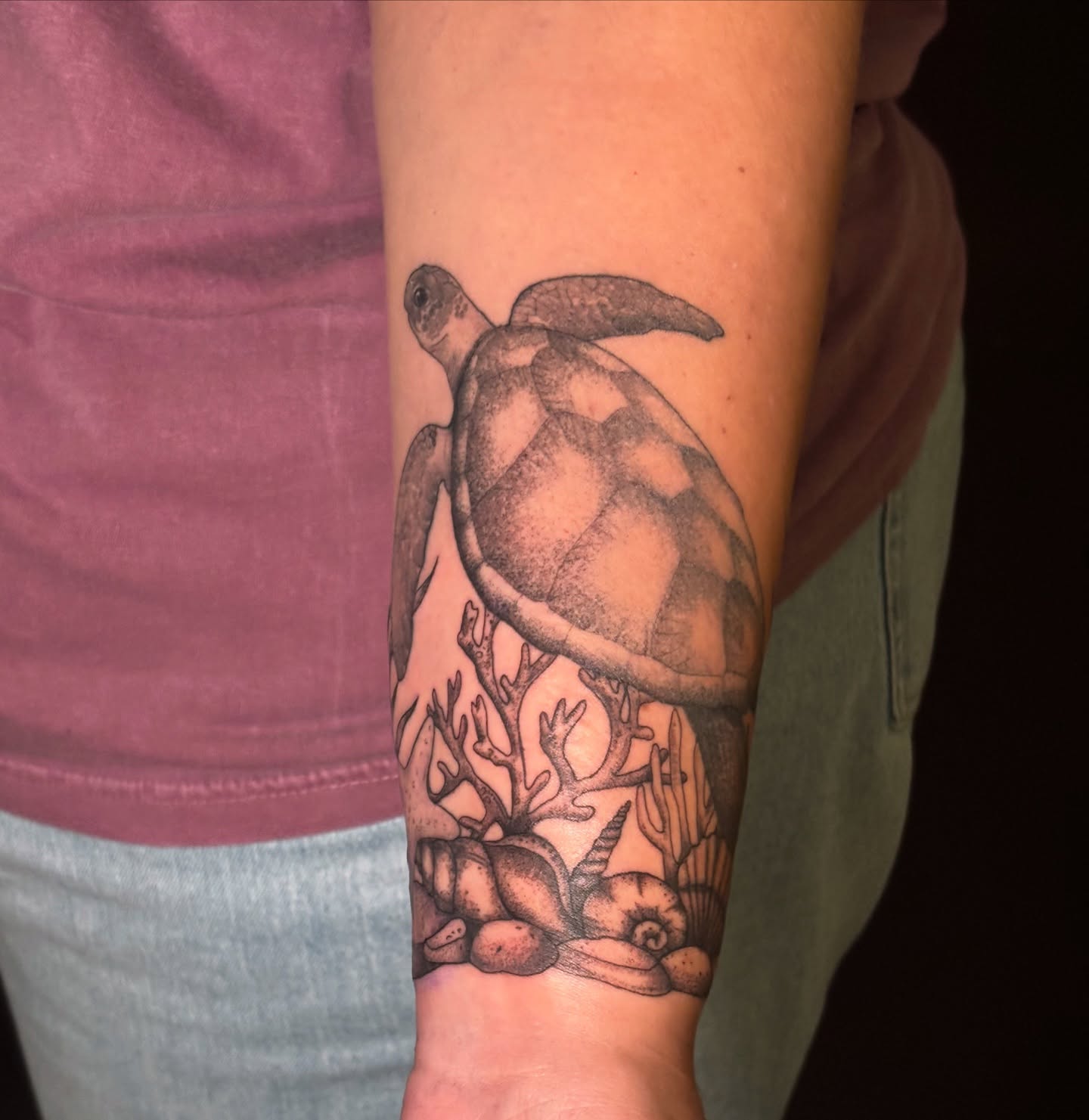 Turtle and coral dotwork tattoo on the forearm by Sarah Sacco