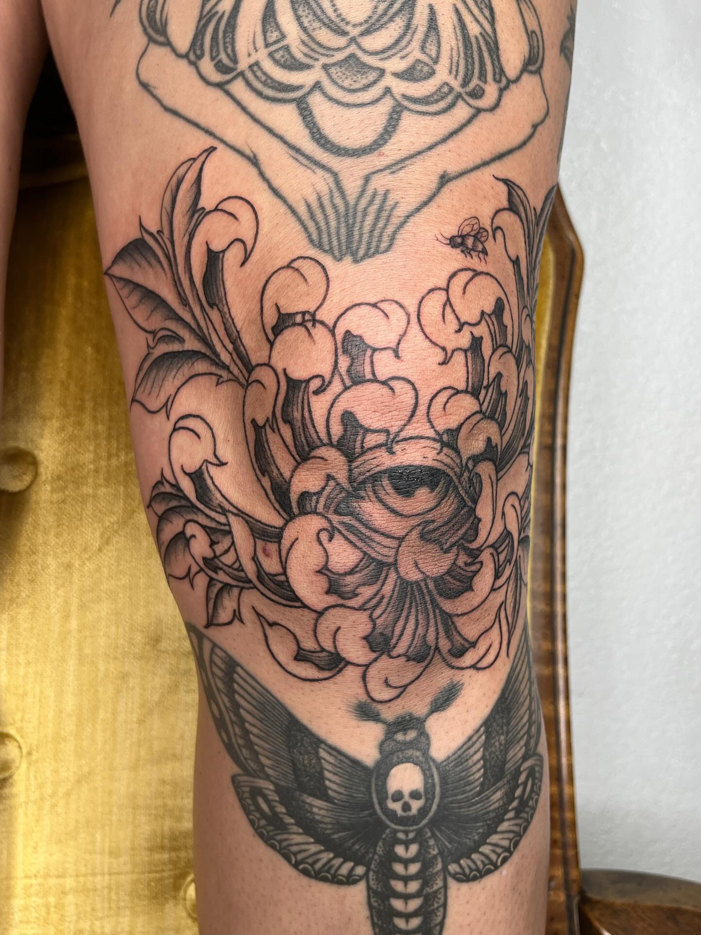Eye and floral ornamental tattoo on the forearm by Janelle McCarthy