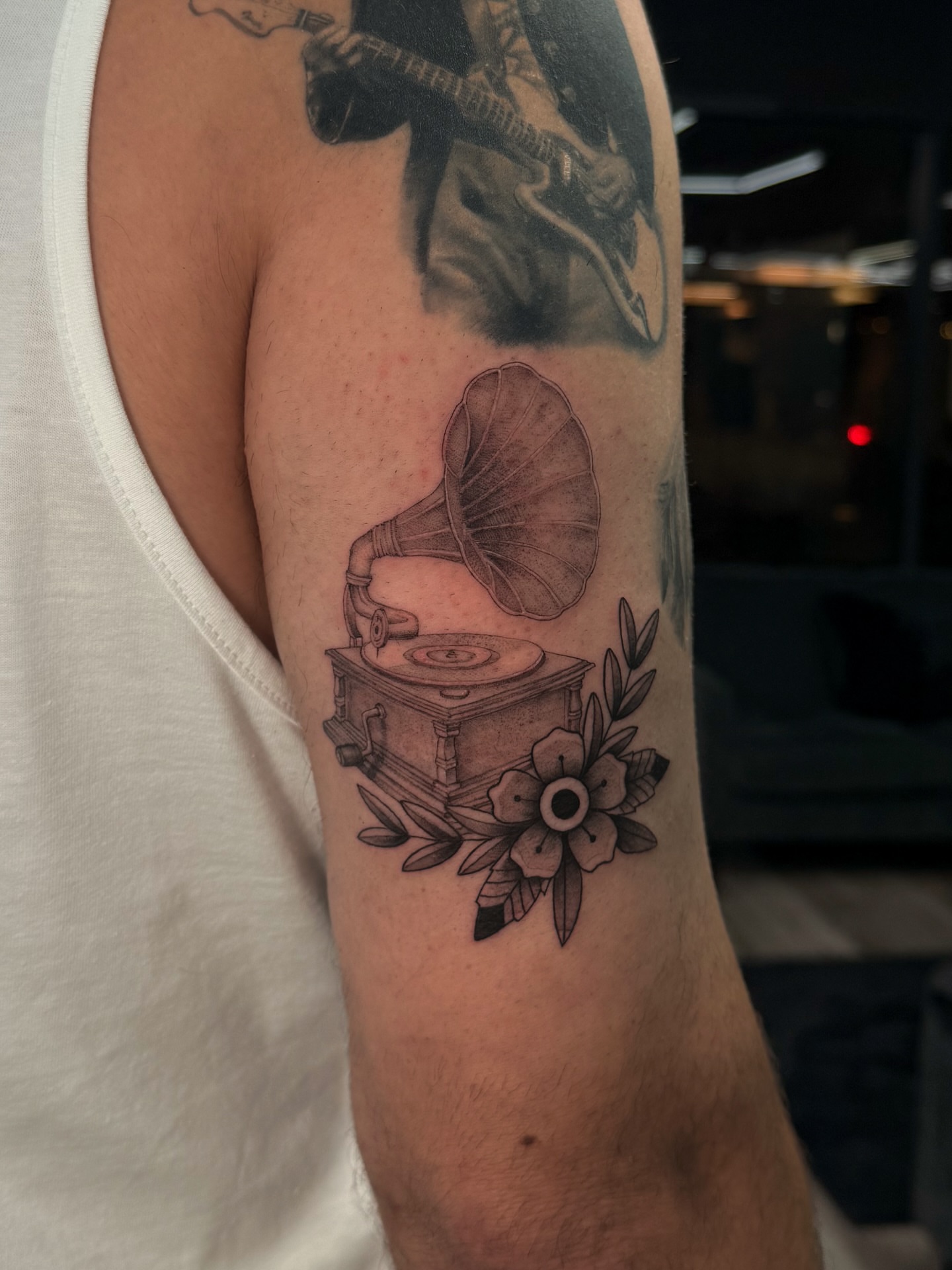 Gramophone black and grey tattoo on the forearm by Nicolas Herrera