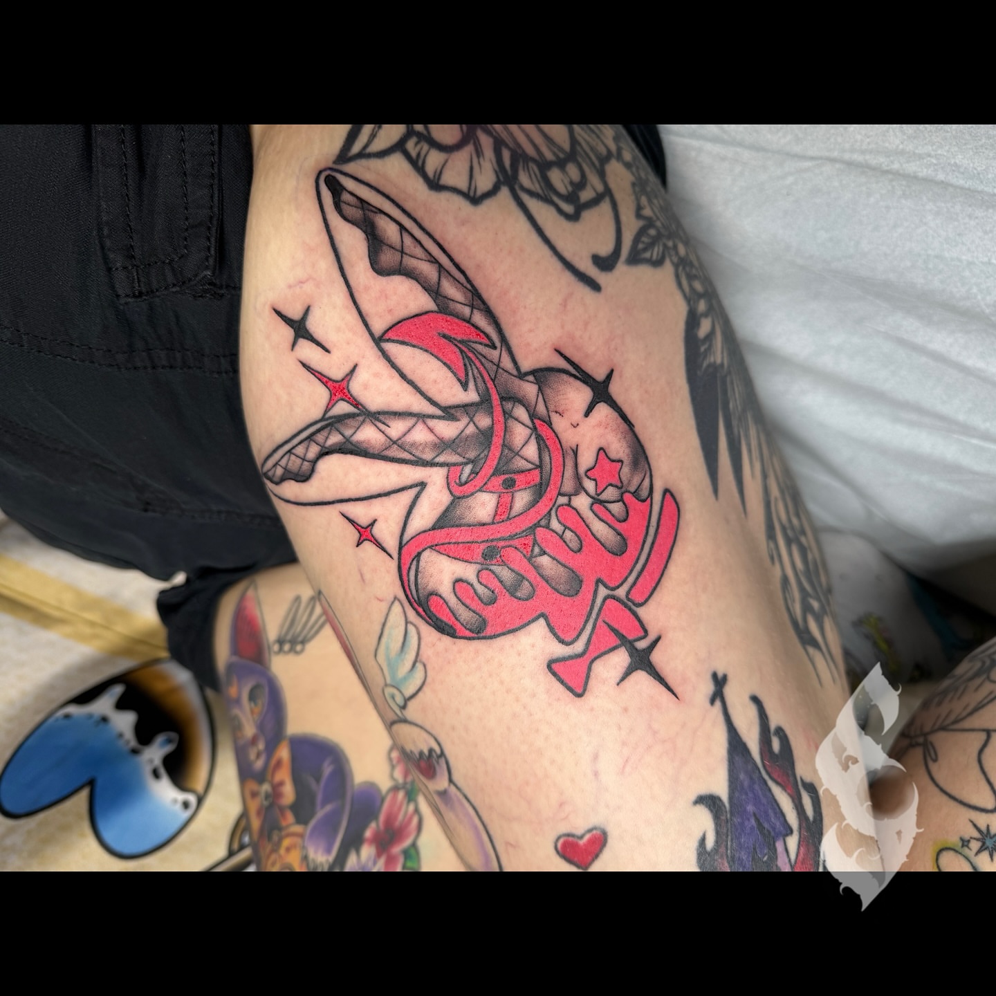 Red ribbon with stars American traditional tattoo on the thigh by Amanda Stampfly