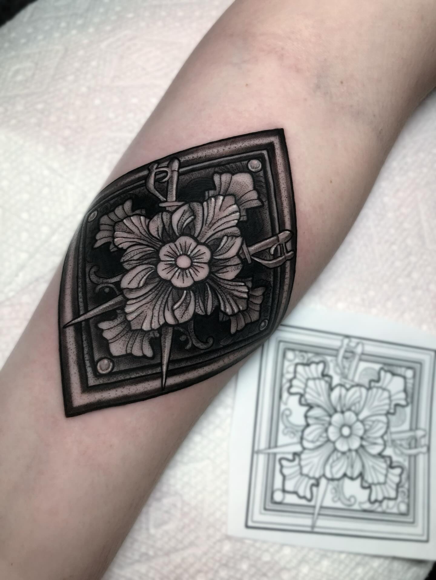 Floral design geometric tattoo on the forearm by Melissa Brown