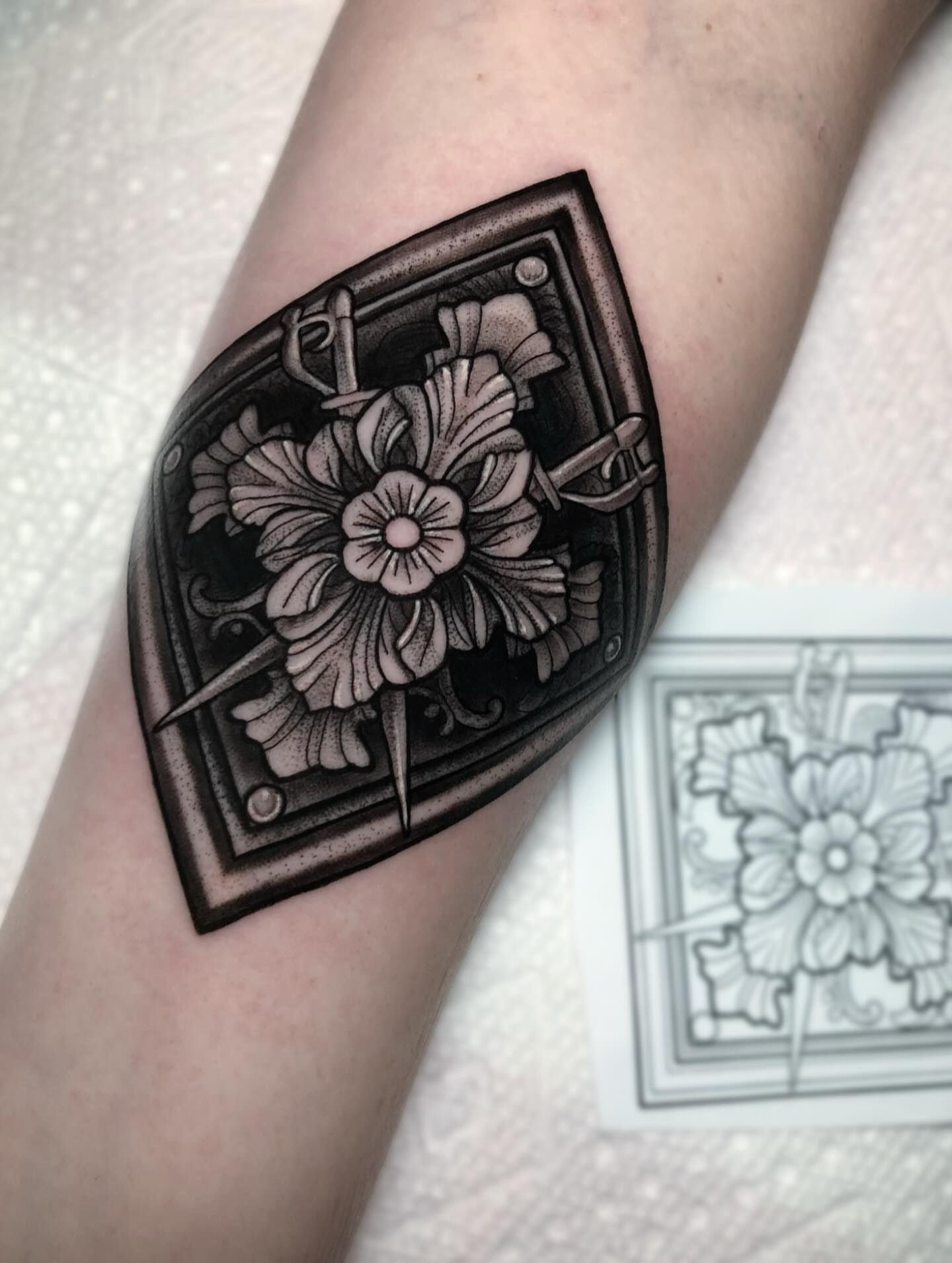 Floral design black and grey tattoo on the forearm by Melissa Brown