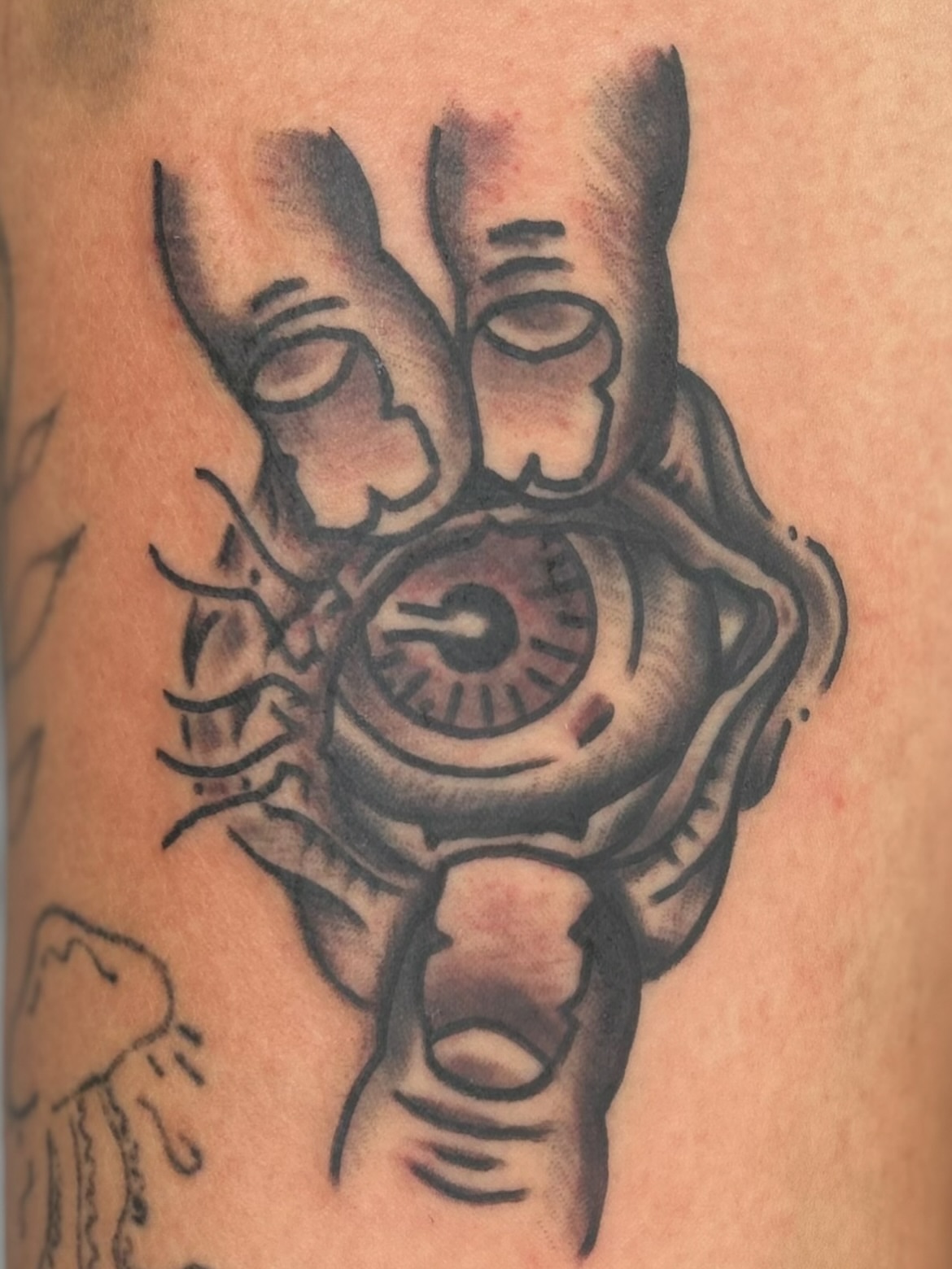 Eye and hand black and grey tattoo on the forearm by Alex Fannin