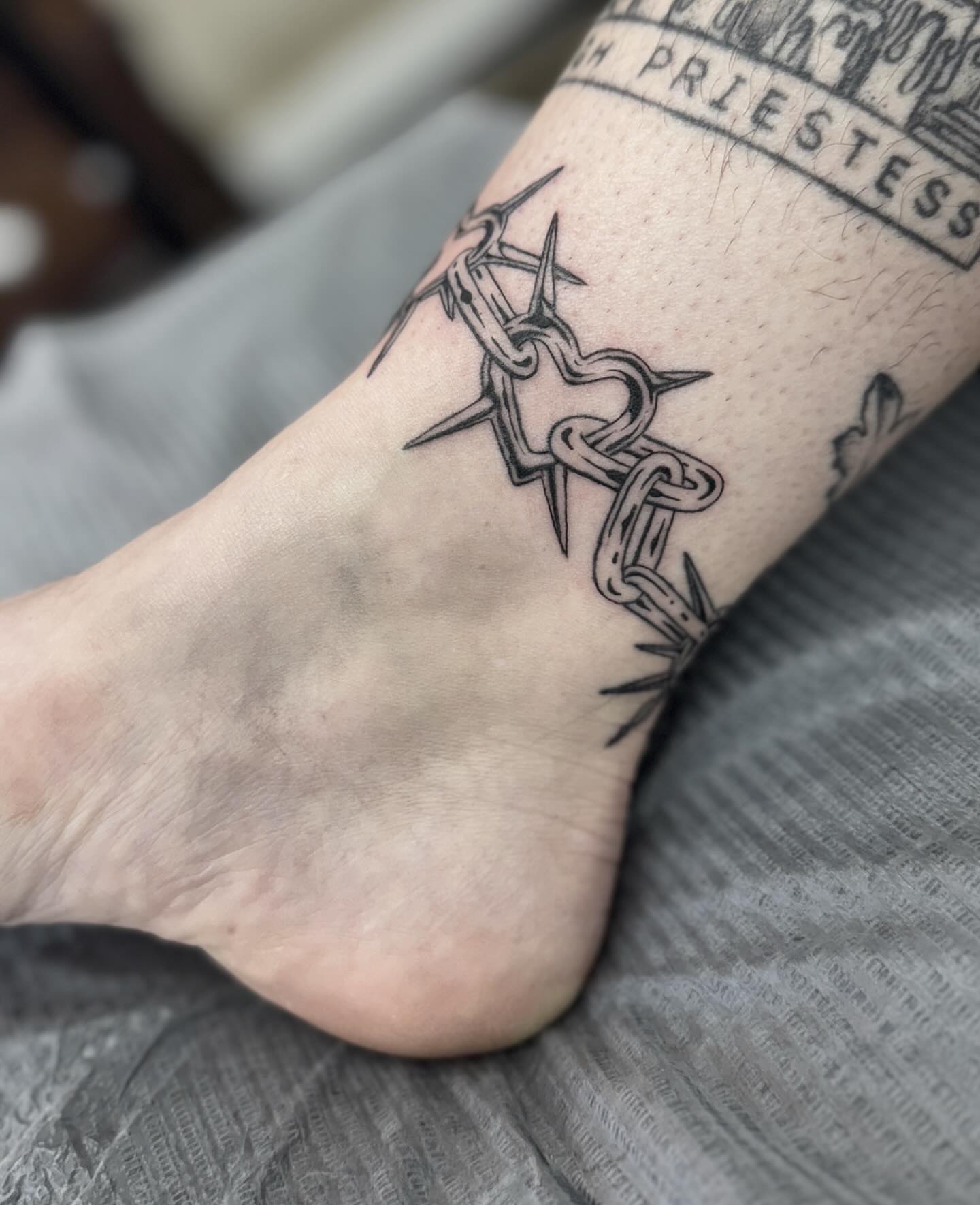 Barbed wire black and grey tattoo on the foot by Writhe Grey