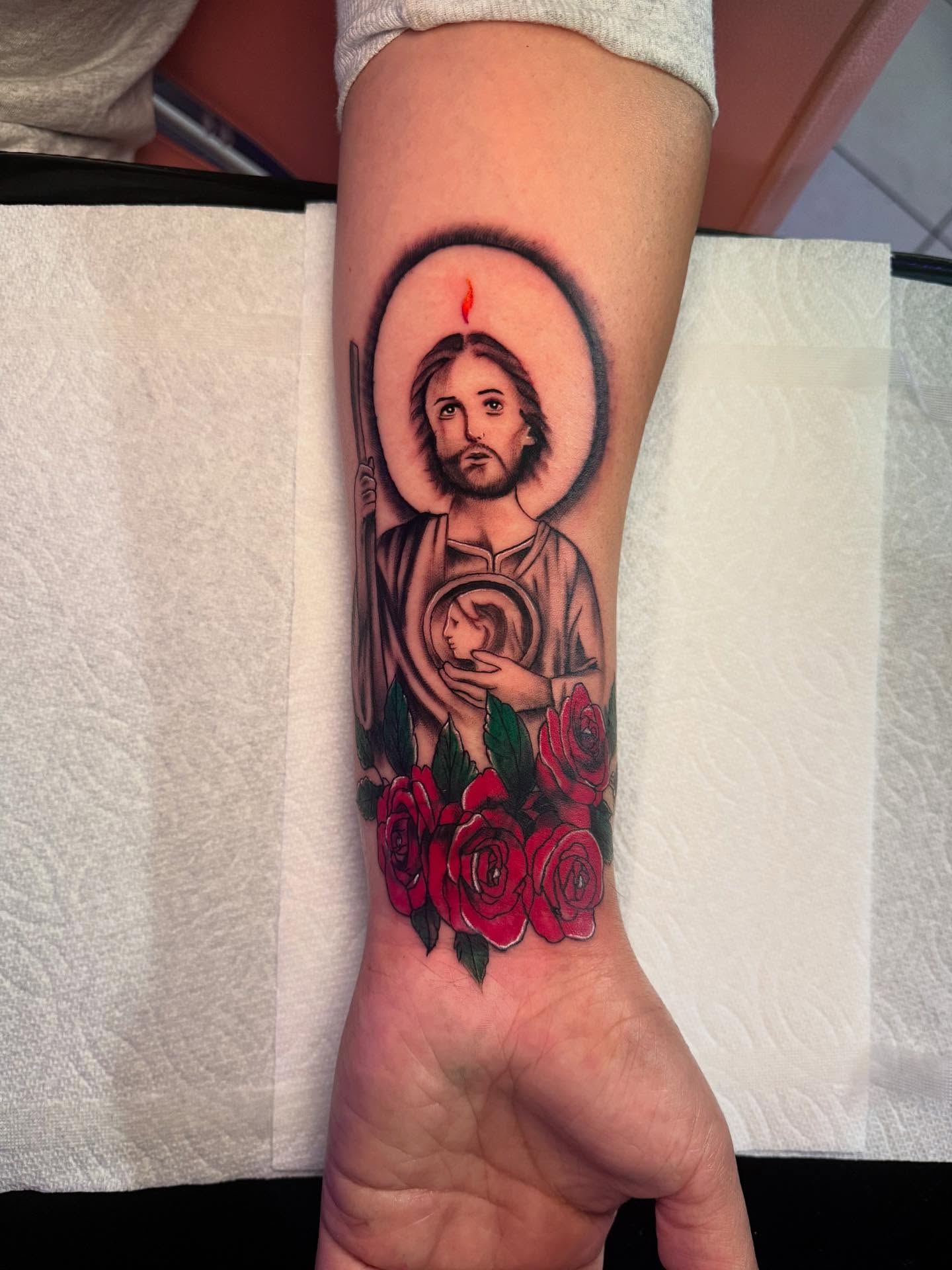 Religious figure with roses realism tattoo on the forearm by Jasmin Lozano