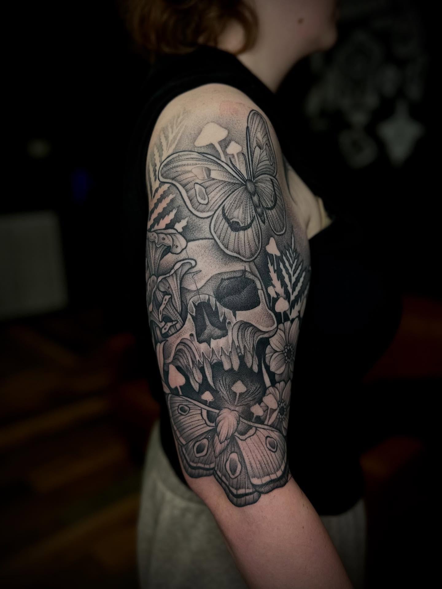 Skull and butterflies realism tattoo on the forearm by Madison Orchard Tattoos