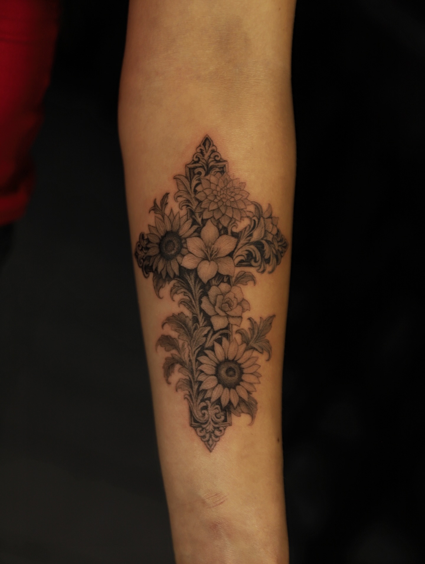Floral cross black and grey tattoo on the forearm by Las Vegas tattoo