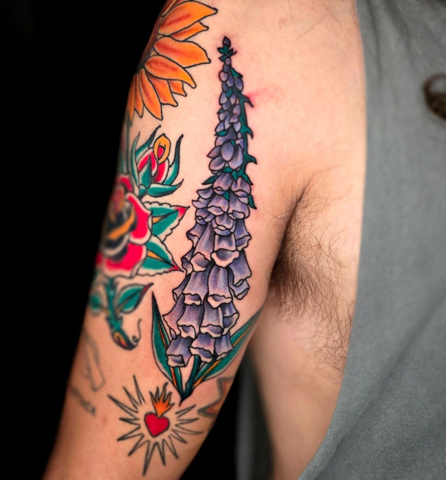 Foxglove flowers American traditional tattoo on the forearm by Adison Essig