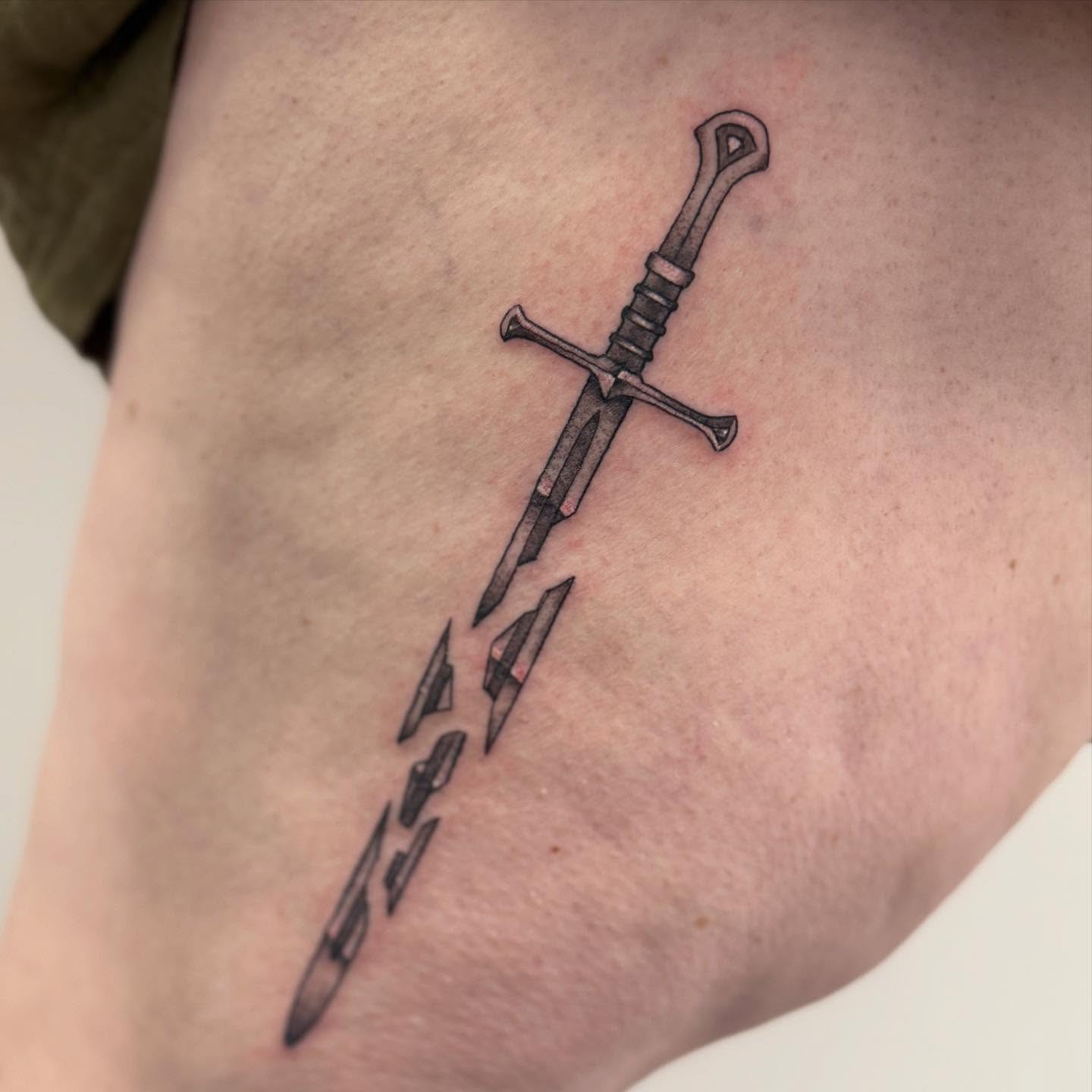 Sword black and grey tattoo on the forearm by Felicity