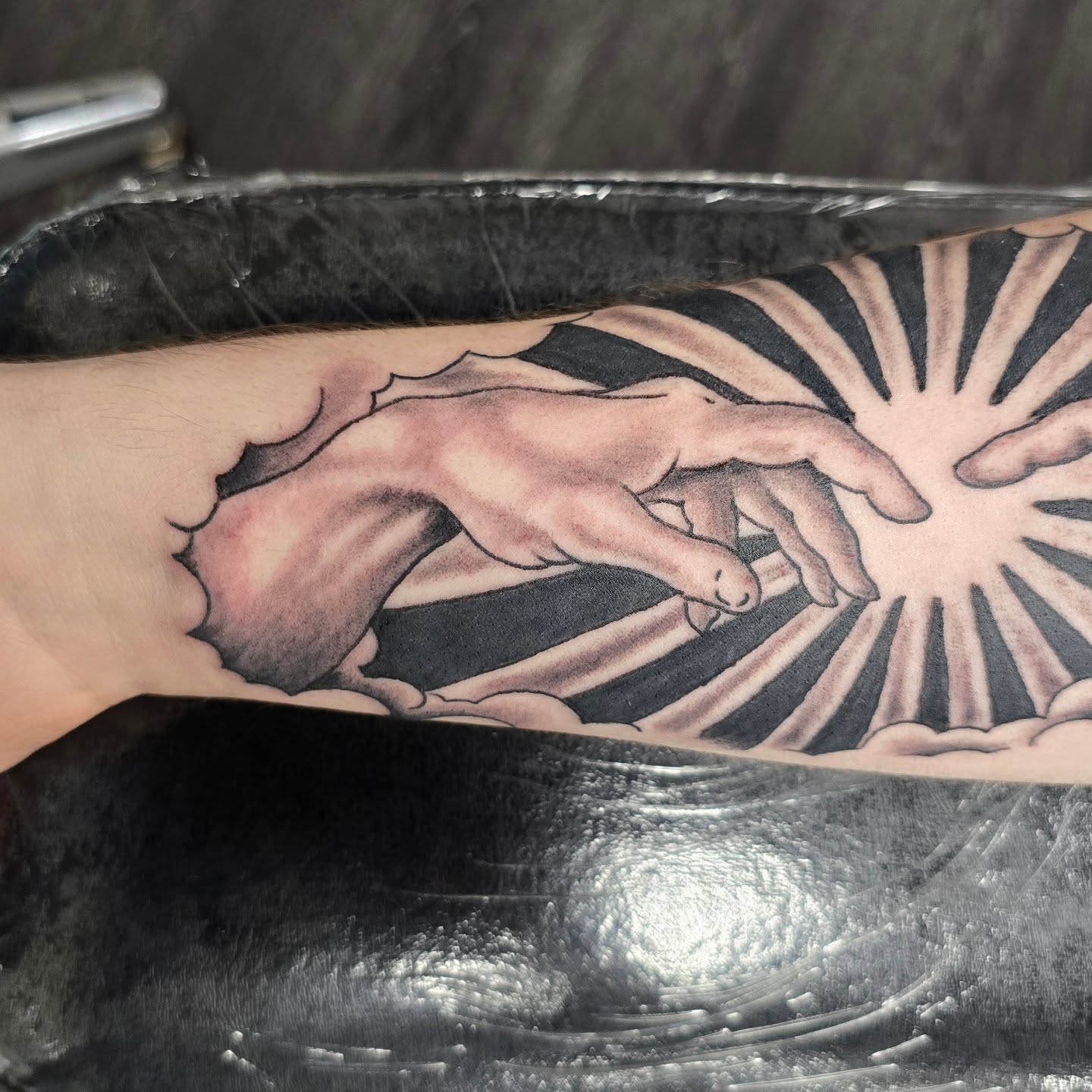 Creation scene realism tattoo on the forearm by Columbus tattoo artist