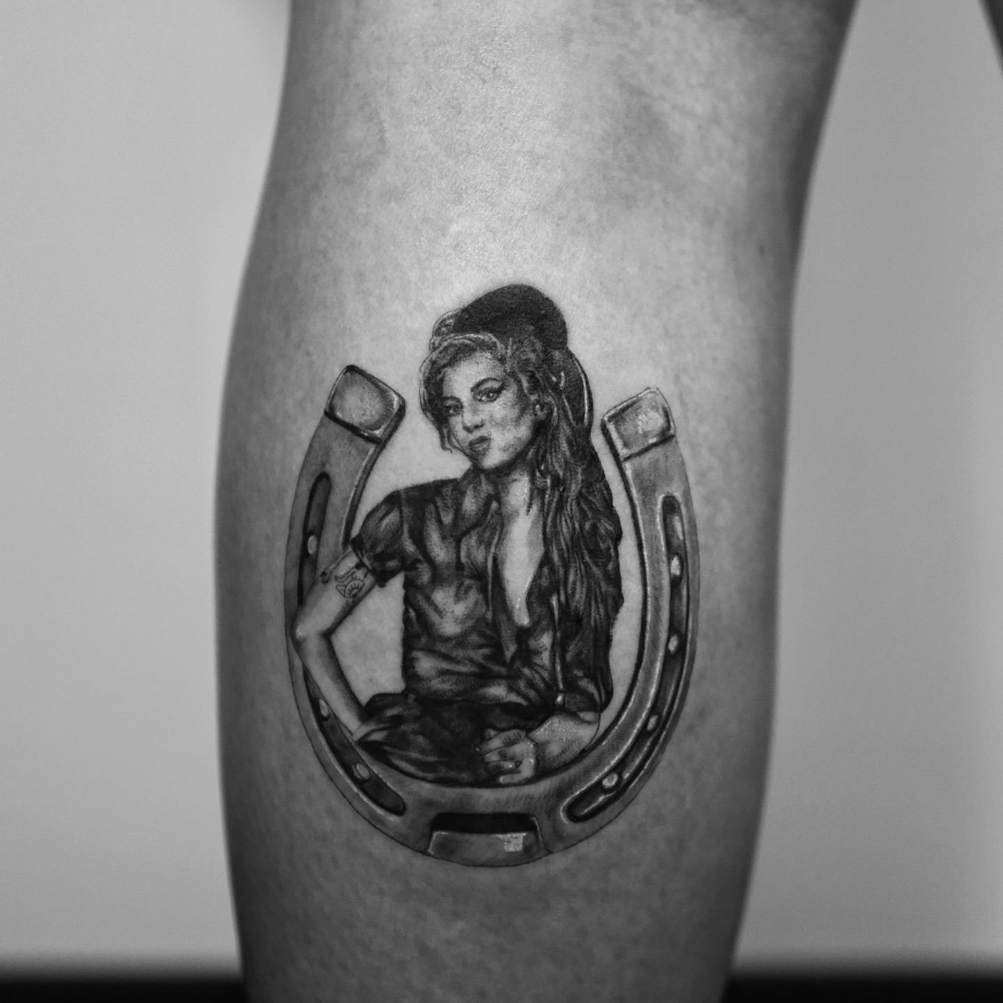 Woman in horseshoe realism tattoo on the forearm by Ross Clark Tattoos