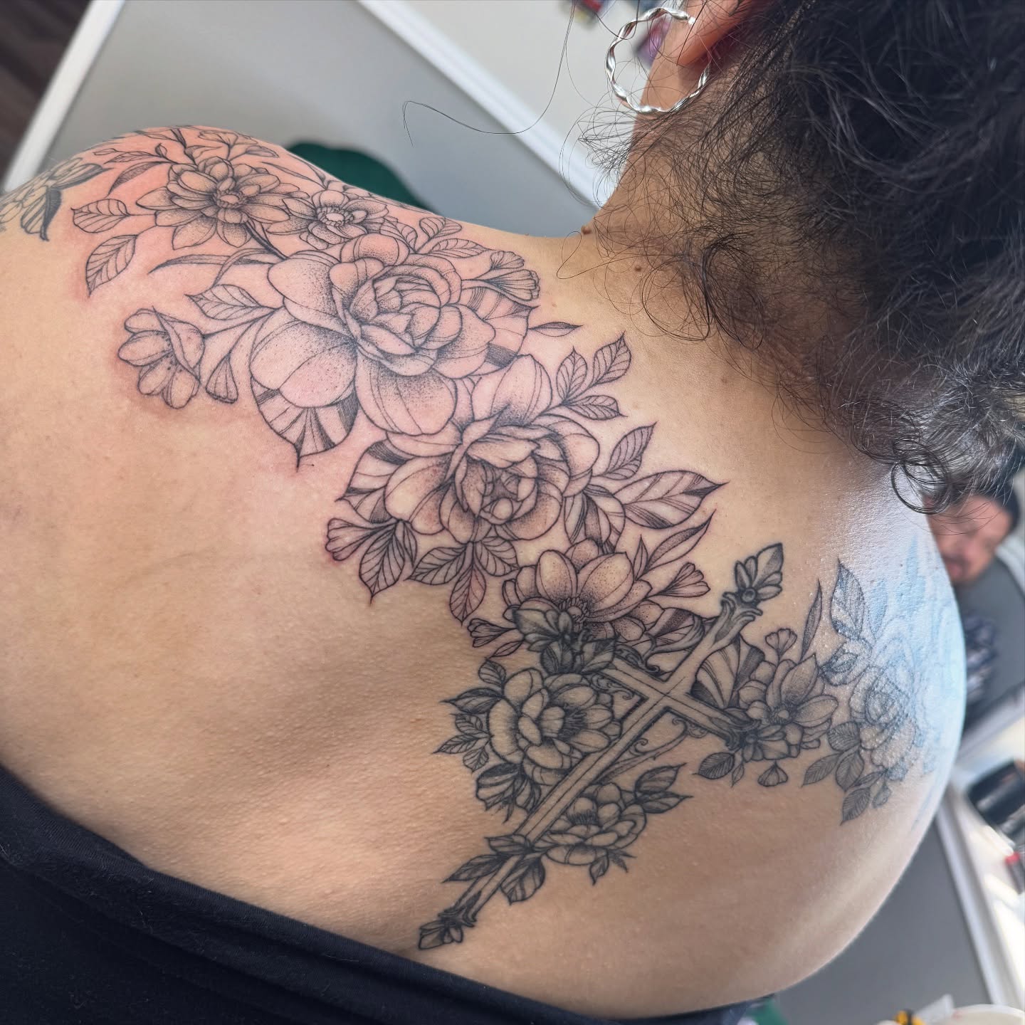 Flowers and cross black and grey tattoo on the back by Mo Dinero🎰