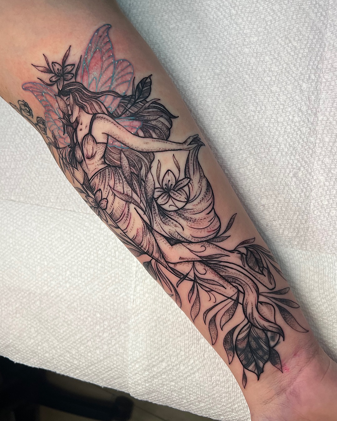 Fairy with flowers neo-traditional tattoo on the forearm by @shannonkeeleyy