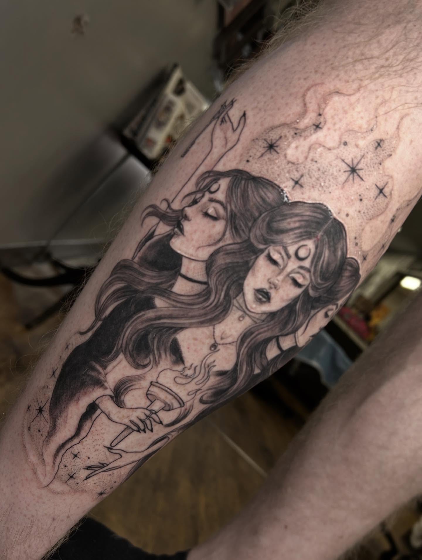 Two women embracing realism tattoo on the forearm by Ashlee Mshar