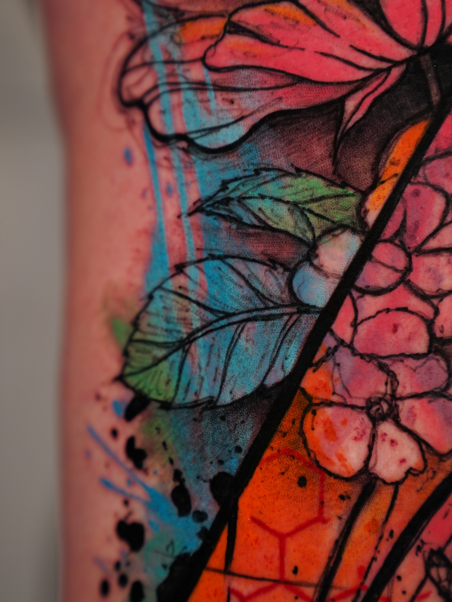 Flower and leaves watercolor tattoo on the forearm by Georgios Papadopoulos Tattoo Artist Los