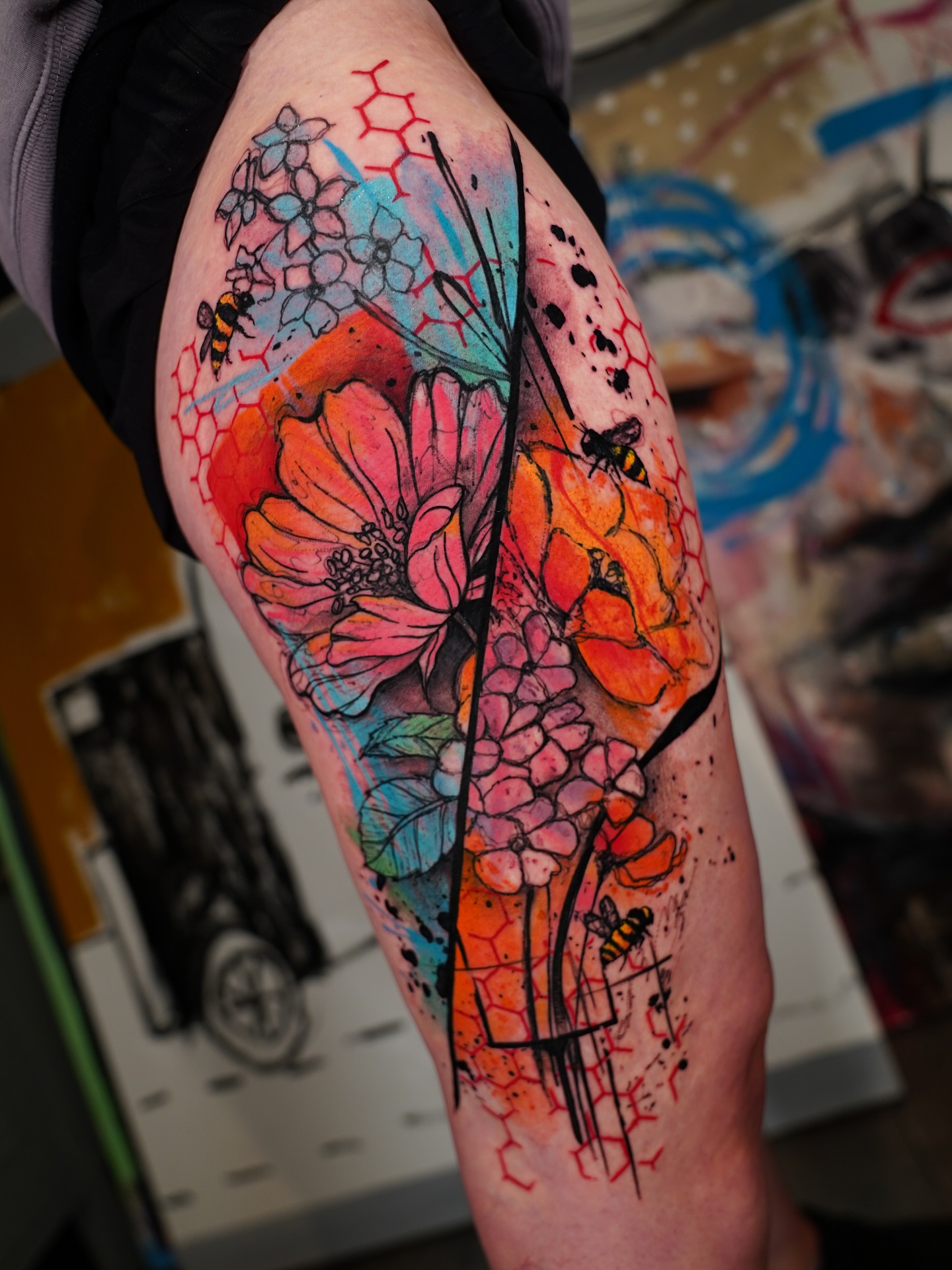 Floral bouquet watercolor tattoo on the thigh by Georgios Papadopoulos Tattoo Artist Los