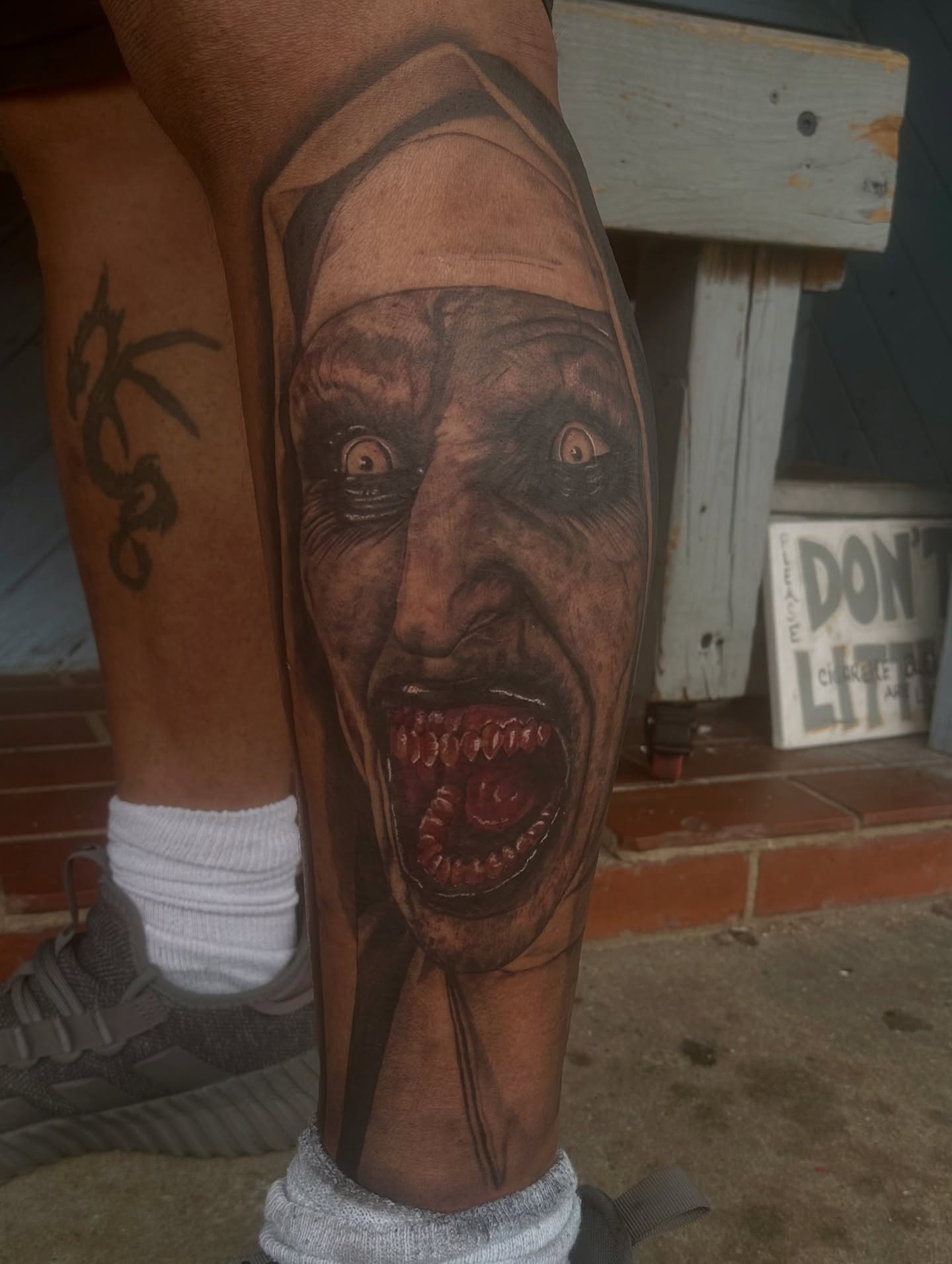 Horror clown realism tattoo on the calf by Carly🪲 greensboro tattoo artist, Greensboro, North Carolina
