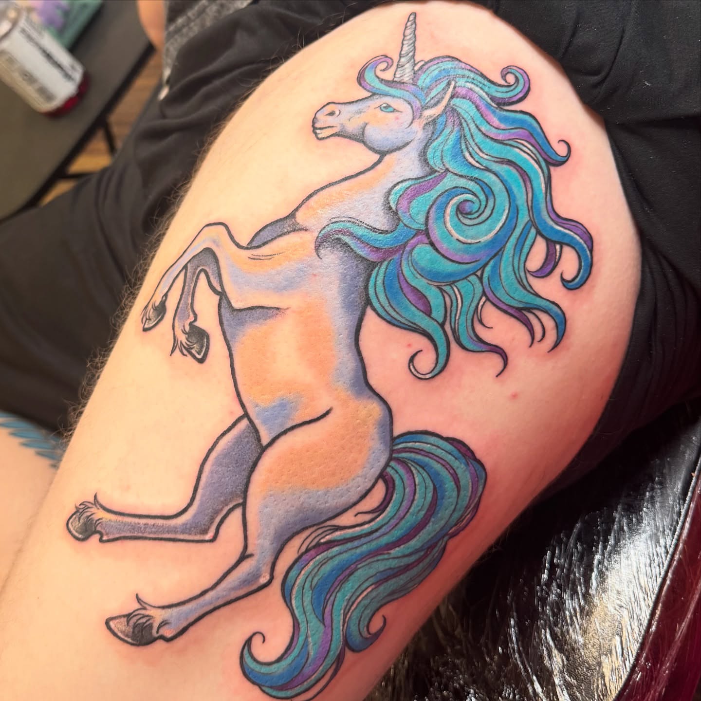 Unicorn new school tattoo on the thigh by Erin Moore
