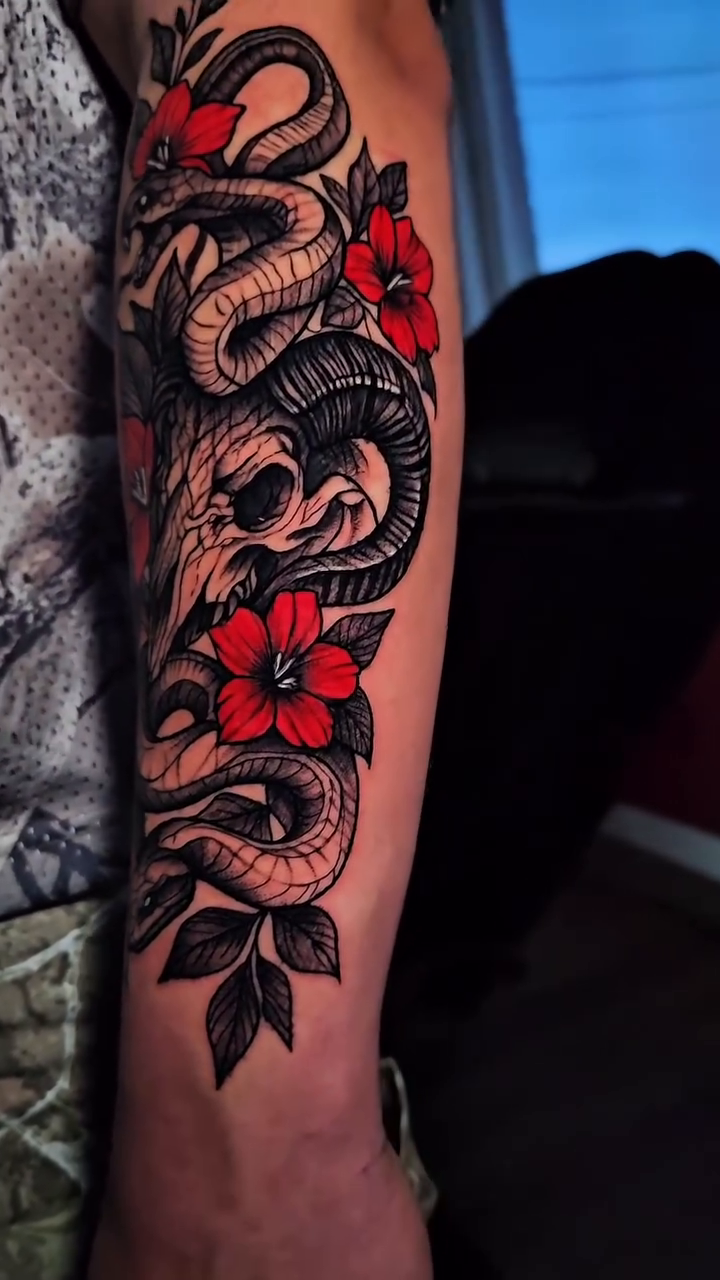 Snake and skull with flowers Japanese tattoo on the forearm by John Briceño, Columbus, Ohio