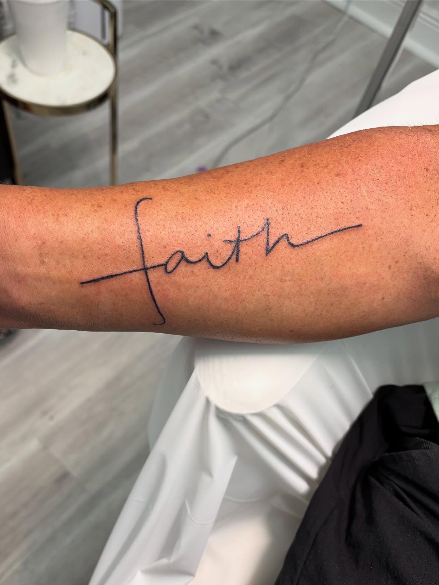Faith lettering script tattoo on the forearm by Victoria Cooper